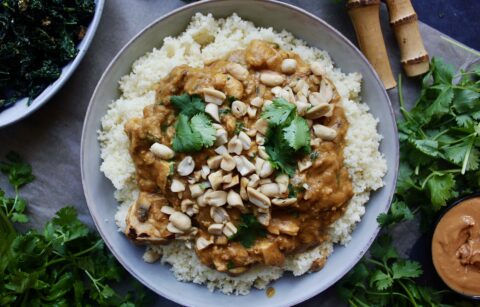 A lighter take on a creamy spiced peanut butter sauce sauteed up with gingery garlicky chicken and served up with wilted kale over your favorite grain: this Healthy African Peanut Chicken is seriously the best comfort food!