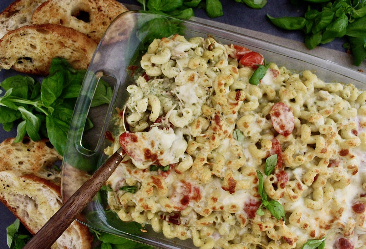 With a base of a creamy pesto cheese sauce, your favorite short cut pasta, and a crispy cheesy top: this Healthier Cheesy Chicken Pesto Pasta Bake is an all time favorite comfort food!