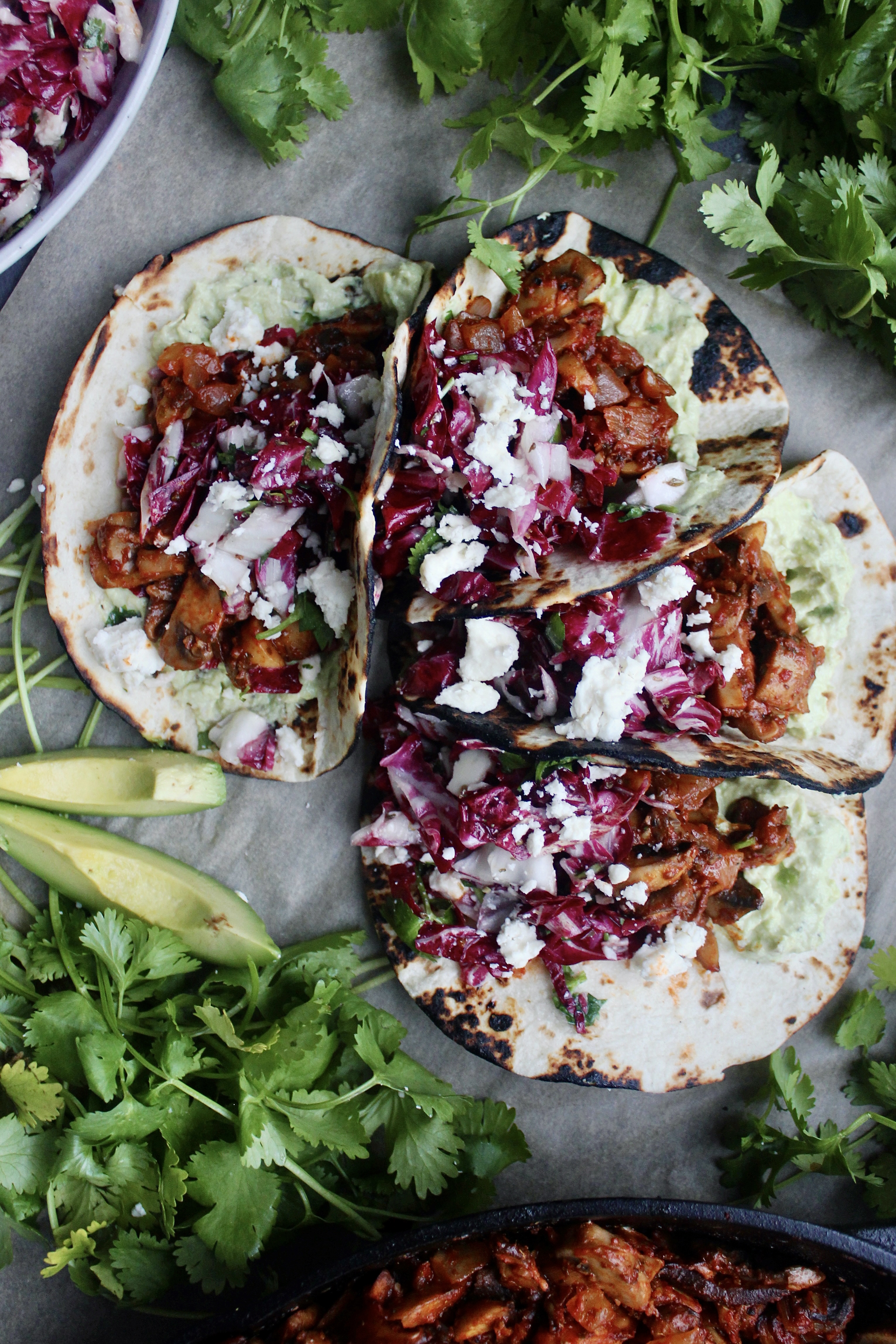 Caramelized, Mexican spiced mushrooms layered over a creamy mashed avocado crema and finished with a tart cotija cilantro slaw: these Caramelized Shiitake Tacos with Cotija Cilantro Slaw are the ultimate vegetarian taco!