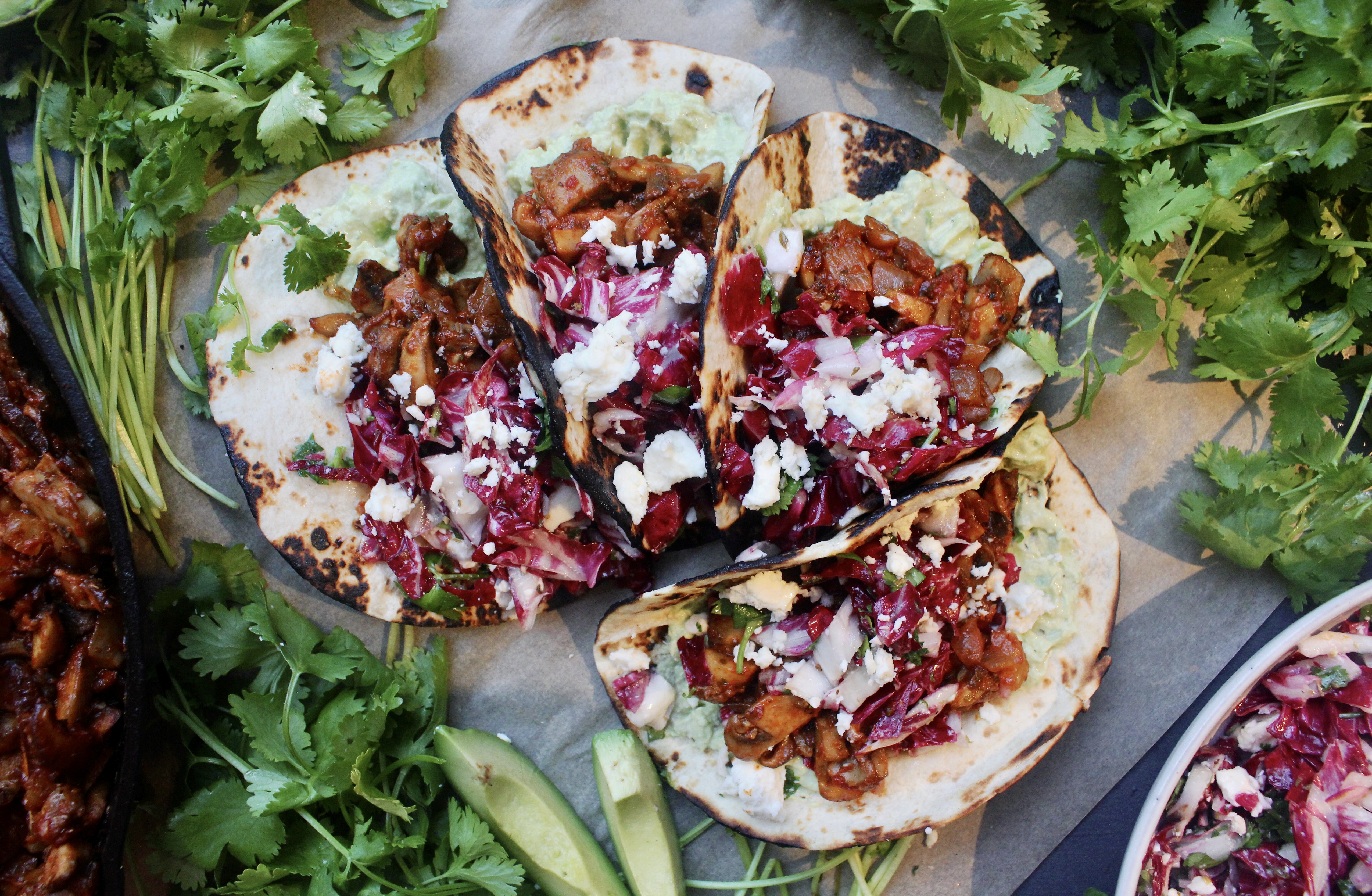 Caramelized, Mexican spiced mushrooms layered over a creamy mashed avocado crema and finished with a tart cotija cilantro slaw: these Caramelized Shiitake Tacos with Cotija Cilantro Slaw are the ultimate vegetarian taco!