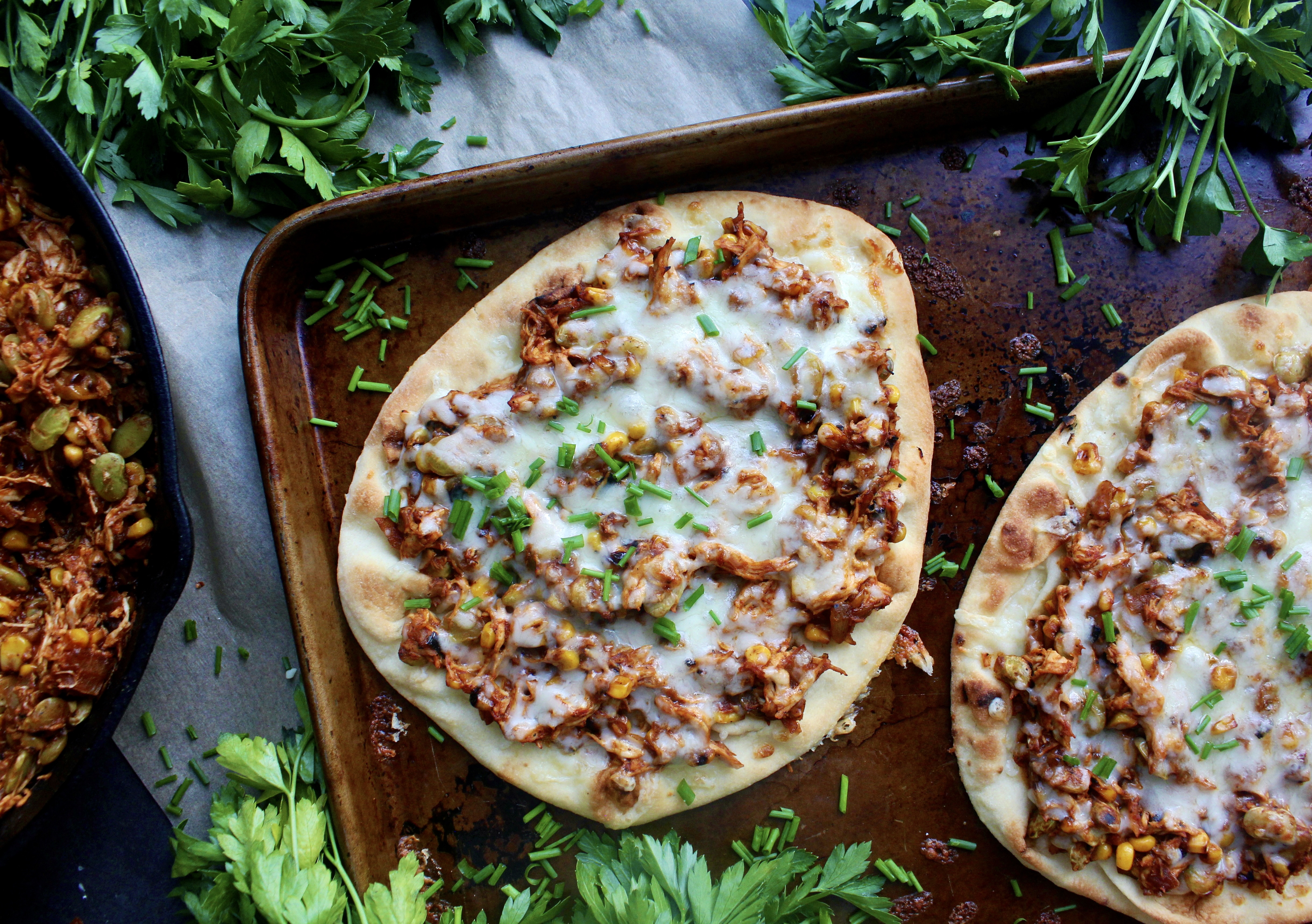 Plushy and toasty Naan flatbreads layered with saucy Brunswick stew style pulled meat and veggies: these Southern Brunswick Stew Naan Flatbreads are the ultimate twist on the classic stew!!