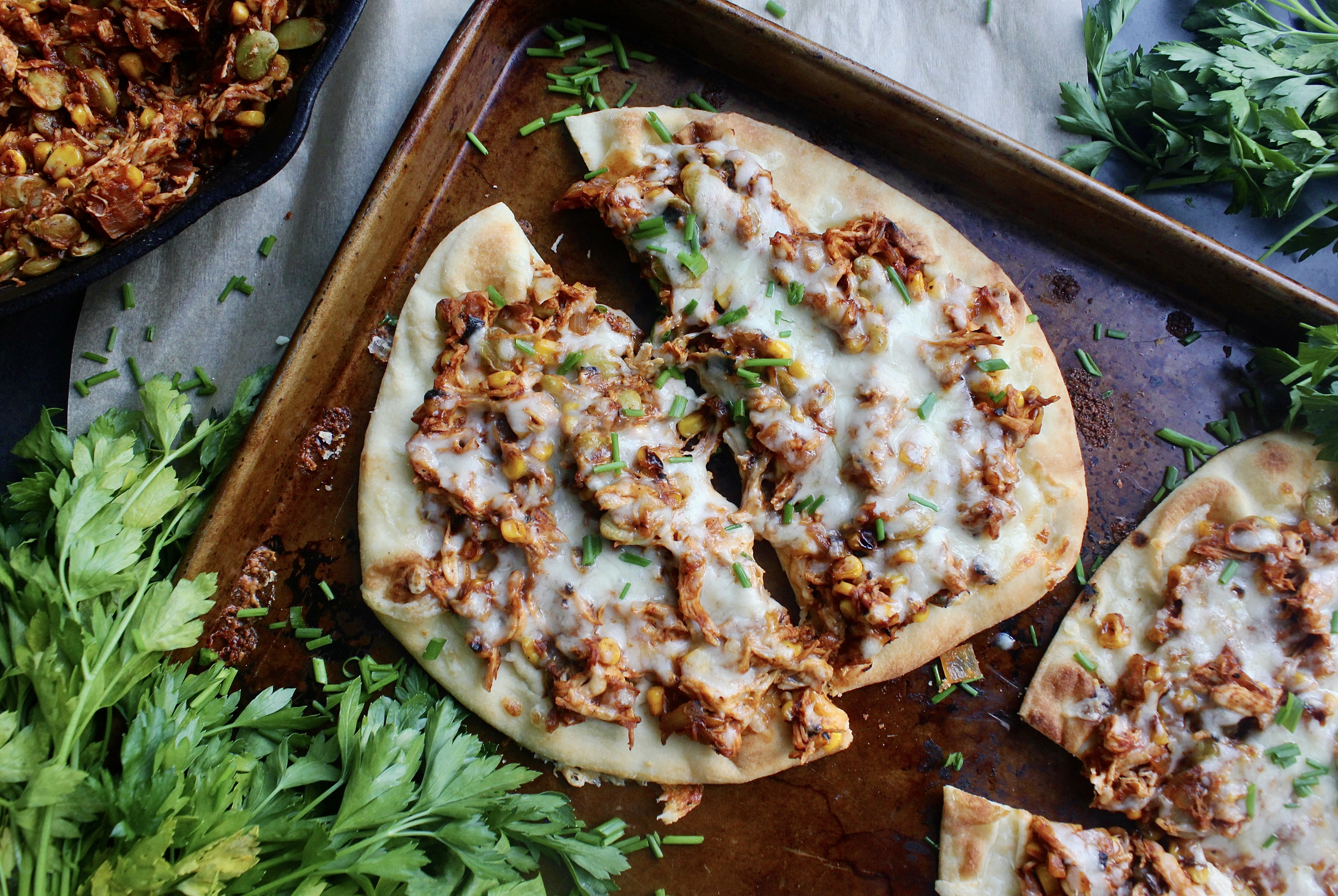 Plushy and toasty Naan flatbreads layered with saucy Brunswick stew style pulled meat and veggies: these Southern Brunswick Stew Naan Flatbreads are the ultimate twist on the classic stew!!