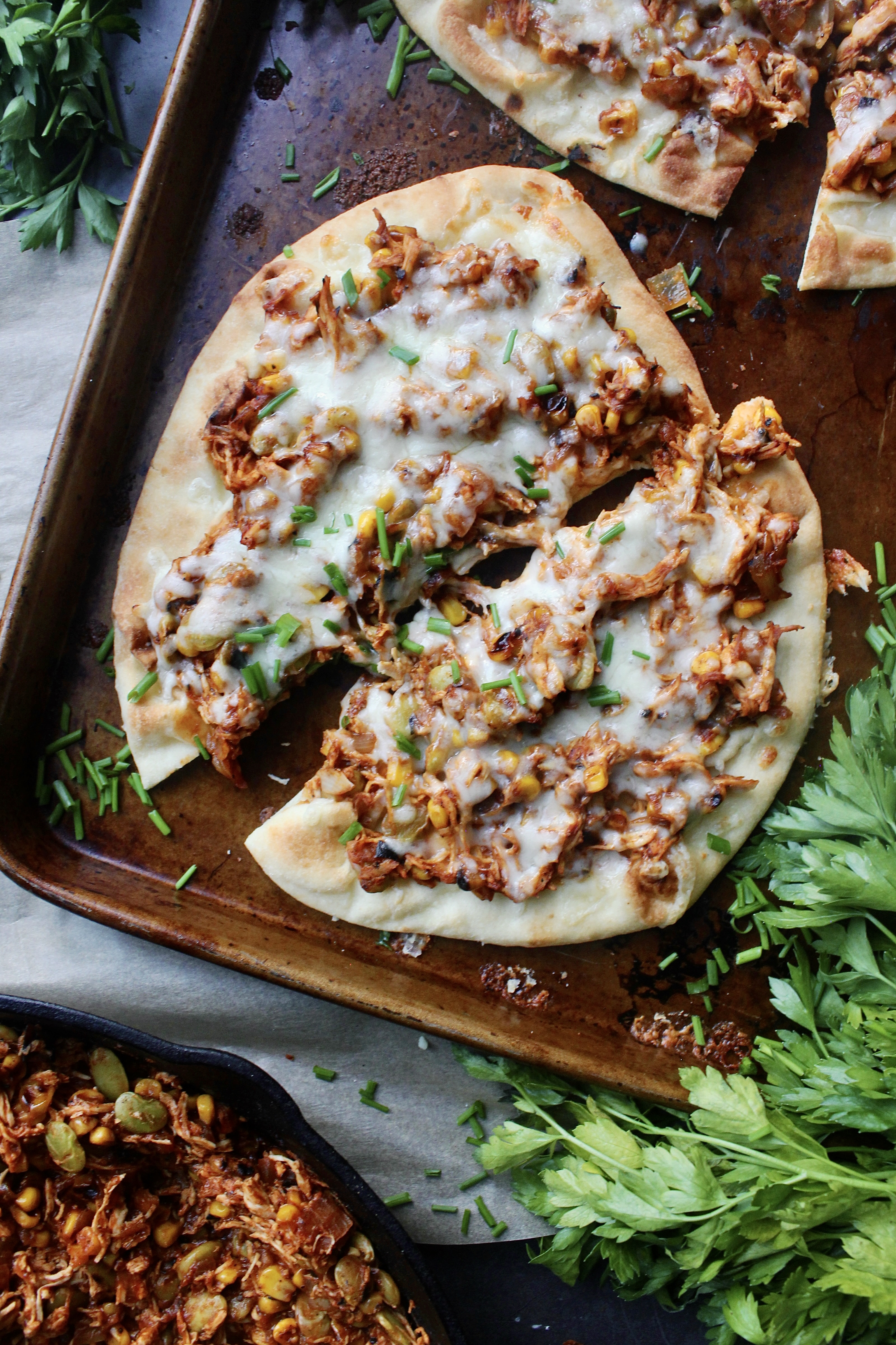 Plushy and toasty Naan flatbreads layered with saucy Brunswick stew style pulled meat and veggies: these Southern Brunswick Stew Naan Flatbreads are the ultimate twist on the classic stew!!