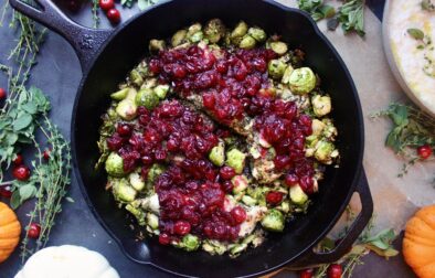 Golden seared chicken and crispy brussels baked with a perfectly sweet and tart cranberry sauce and topped with goat cheese and pecans: this Cranberry Sauce Skillet Chicken and Brussels is the ultimate fall dinner.