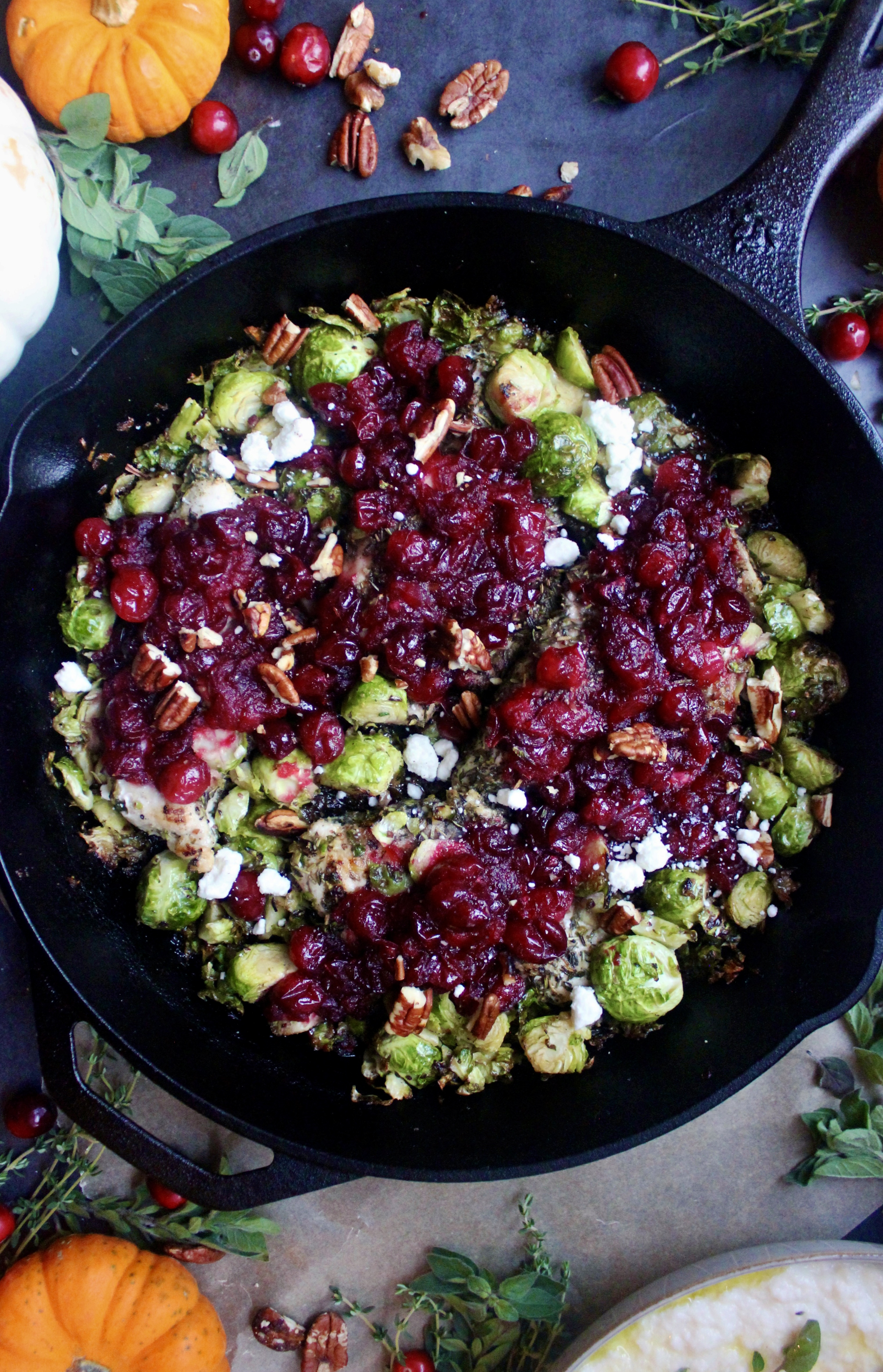 Golden seared chicken and crispy brussels baked with a perfectly sweet and tart cranberry sauce and topped with goat cheese and pecans: this Cranberry Sauce Skillet Chicken and Brussels is the ultimate fall dinner. 