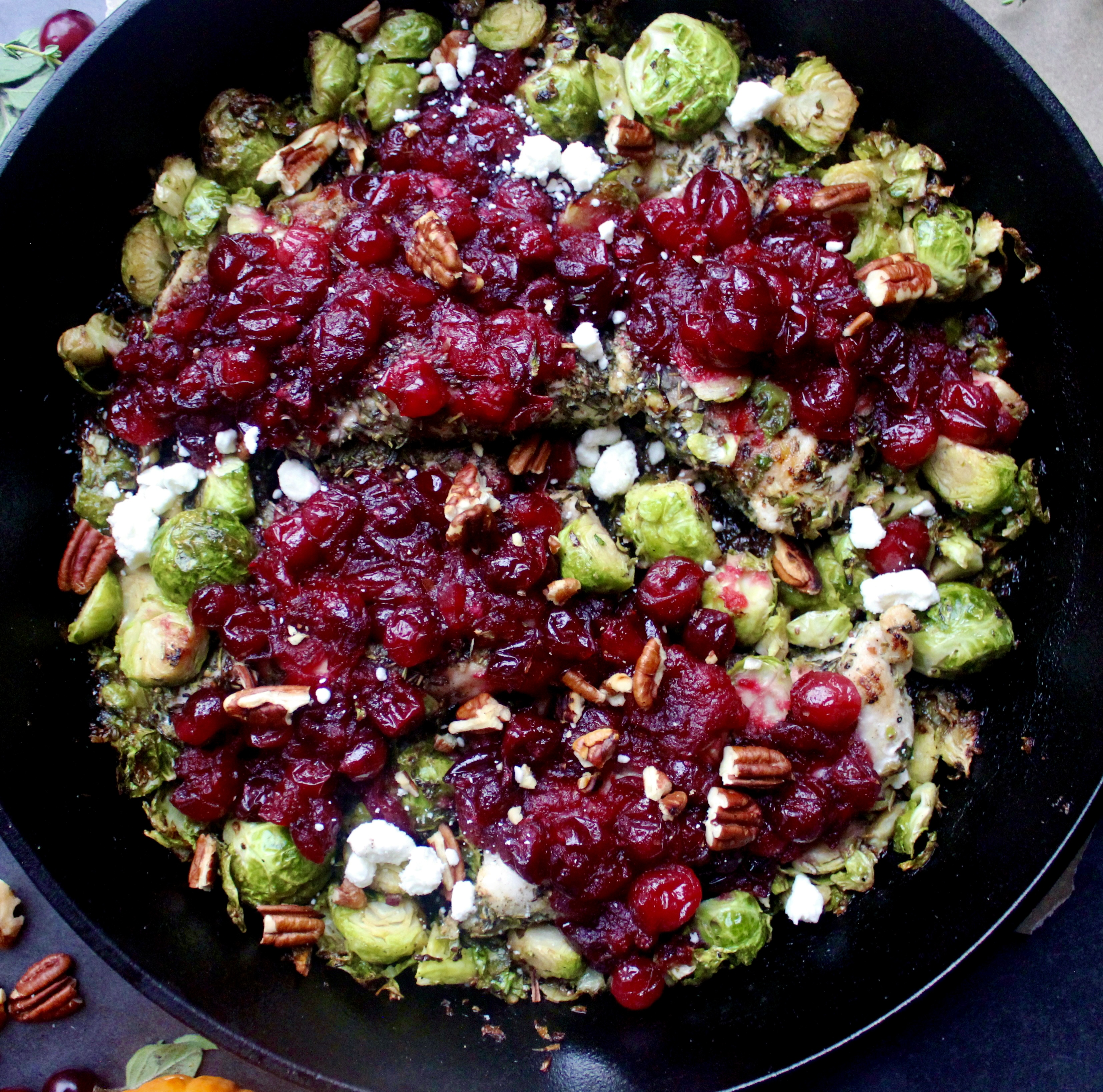 Golden seared chicken and crispy brussels baked with a perfectly sweet and tart cranberry sauce and topped with goat cheese and pecans: this Cranberry Sauce Skillet Chicken and Brussels is the ultimate fall dinner. 