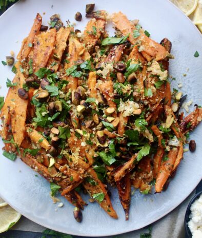 Twice baked, crispy cheese smashed carrots tossed with all the parmesan cheese, fresh parsley, and toasty pistachios: these Parmesan Pistachio Smashed Carrots are the best vegetable side dish. #onanniesmenu #delish #eathealthy #healthyrecipes #eatrealfood #easydinner #easymeal #foodporn #healthyish #eatwellbewell #realfoodz #wholefoodie #glutenfree #familydinner #goodeats #fuel #paleo #healthyfoods #foodblog #foodcoma #comfortfood #weeknightdinner