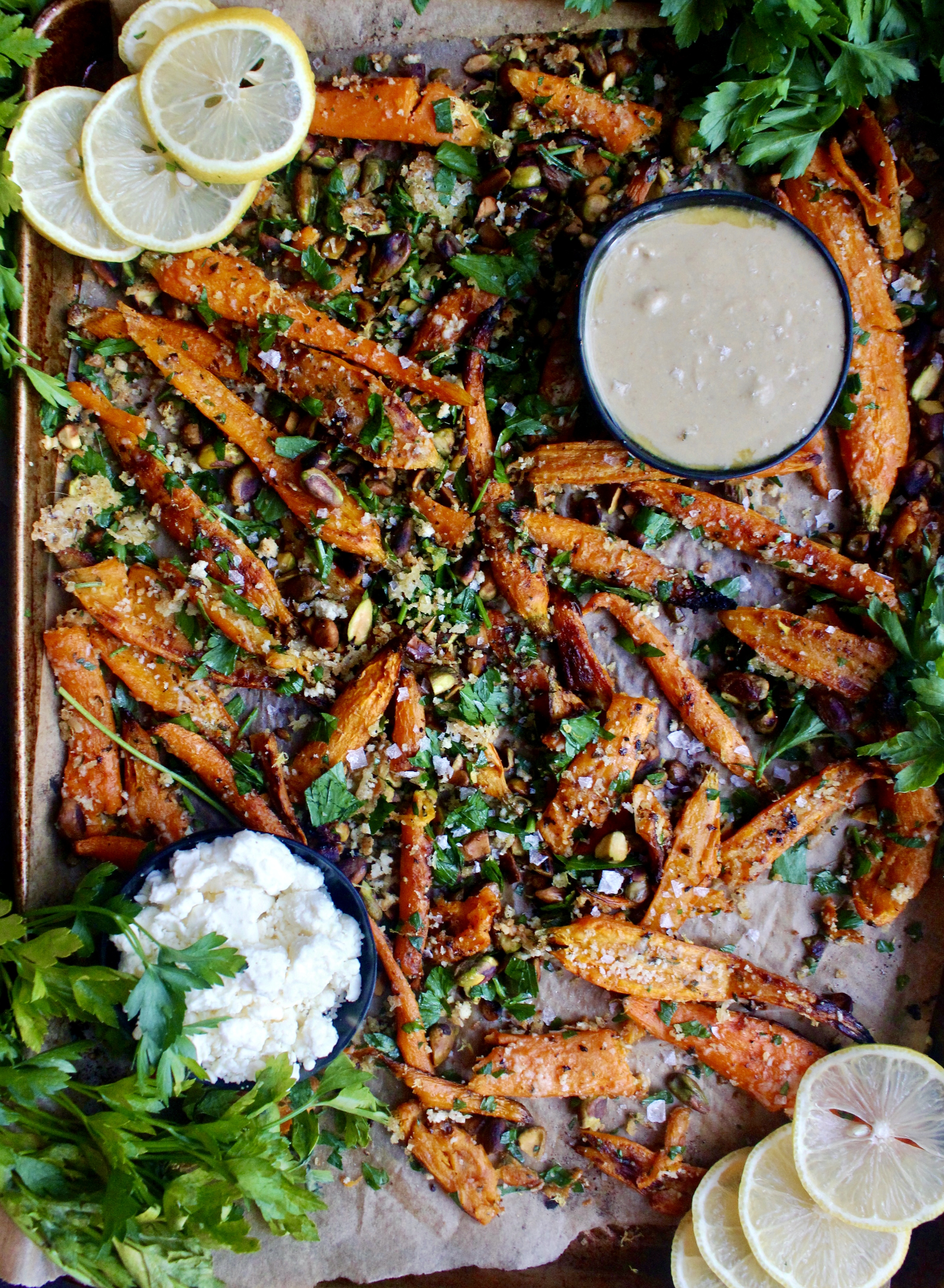 Twice baked, crispy cheese smashed carrots tossed with all the parmesan cheese, fresh parsley, and toasty pistachios: these Parmesan Pistachio Smashed Carrots are the best vegetable side dish.