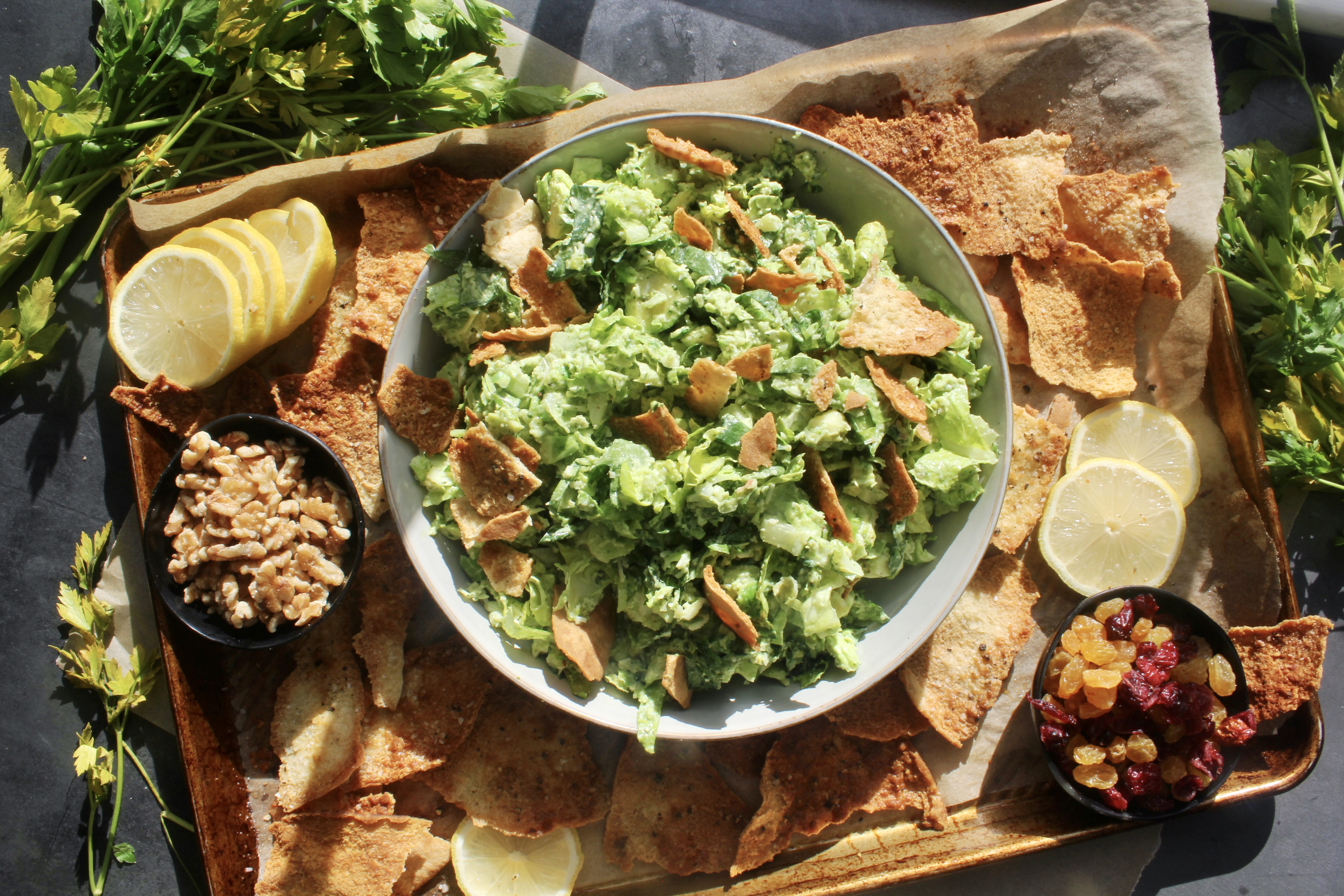 Warm and crispy homemade pita chips chopped up with shredded brussels, kale, some parm, and the creamiest dreamiest avocado dressing: this Avocado Brussels Sprouts Chop with Homemade Pita Chips has to be on this week’s menu!!