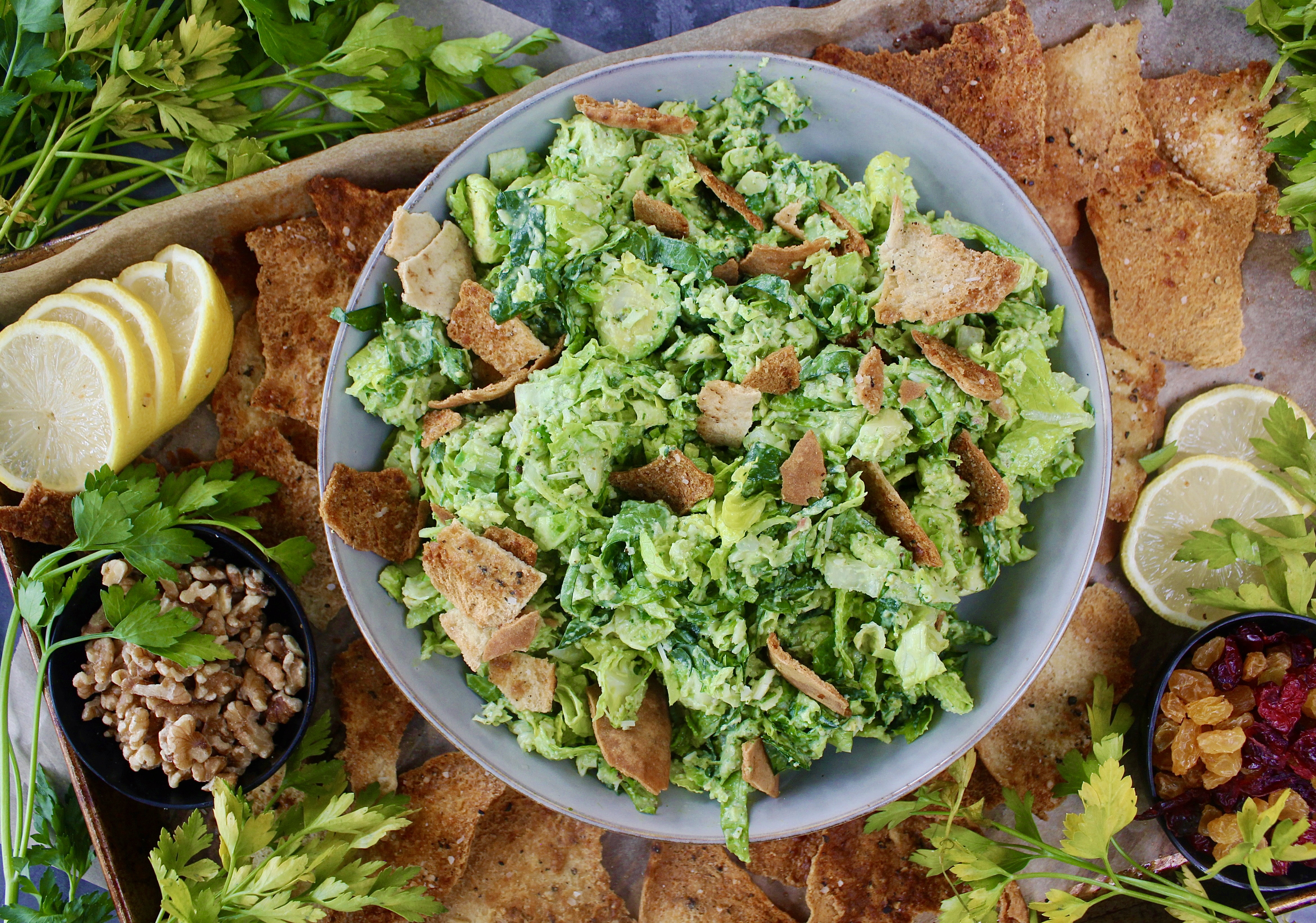 Warm and crispy homemade pita chips chopped up with shredded brussels, kale, some parm, and the creamiest dreamiest avocado dressing: this Avocado Brussels Sprouts Chop with Homemade Pita Chips has to be on this week’s menu!!