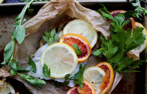 White wine caramelized fennel and shallots under a flaky white fish with layers of blood orange and lemon all tucked into a folded parchment square: this Citrus Fennel Baked Fish en Papillote is truly a package of flavor!