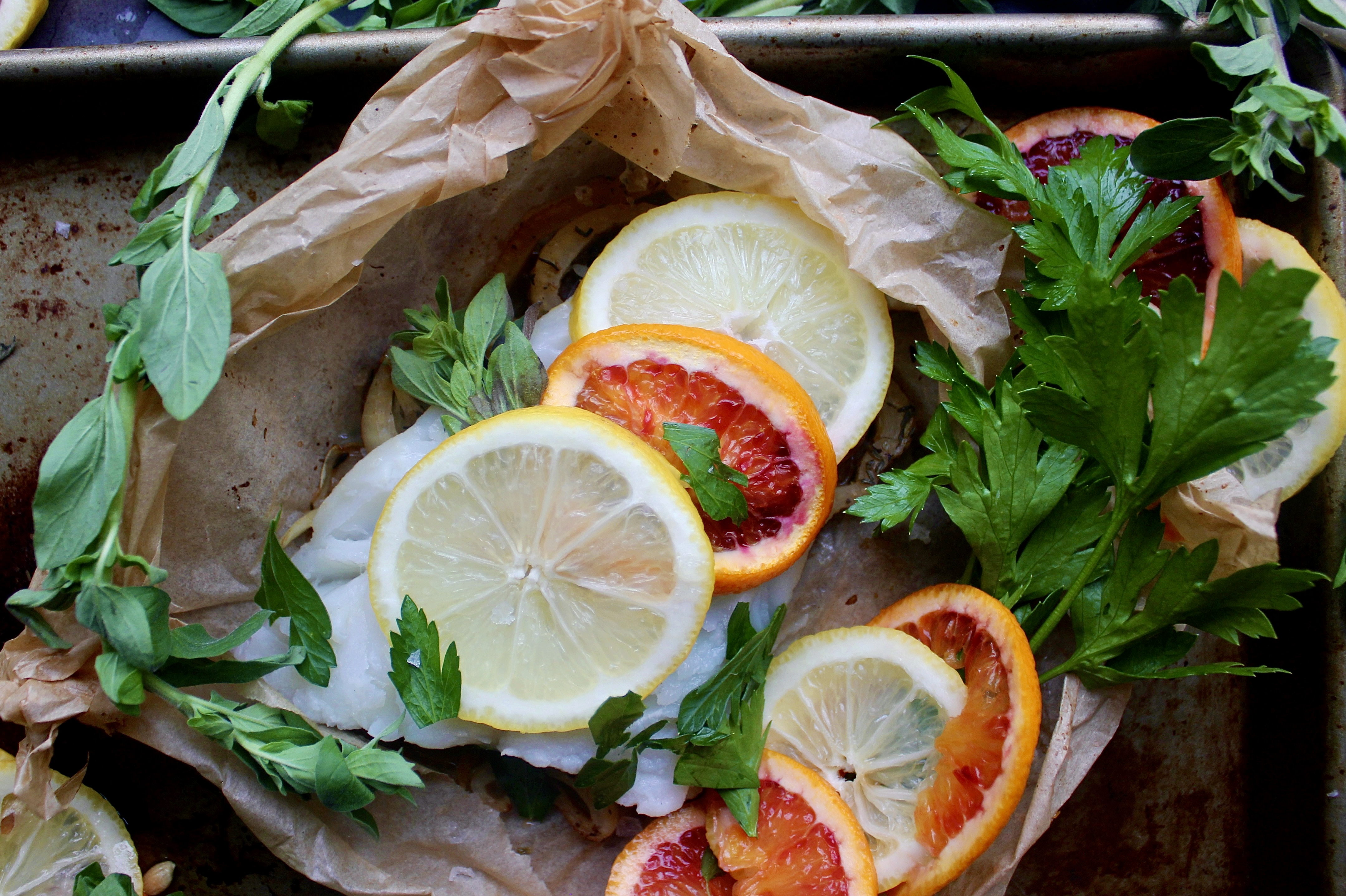 White wine caramelized fennel and shallots under a flaky white fish with layers of blood orange and lemon all tucked into a folded parchment square: this Citrus Fennel Baked Fish en Papillote is truly a package of flavor!