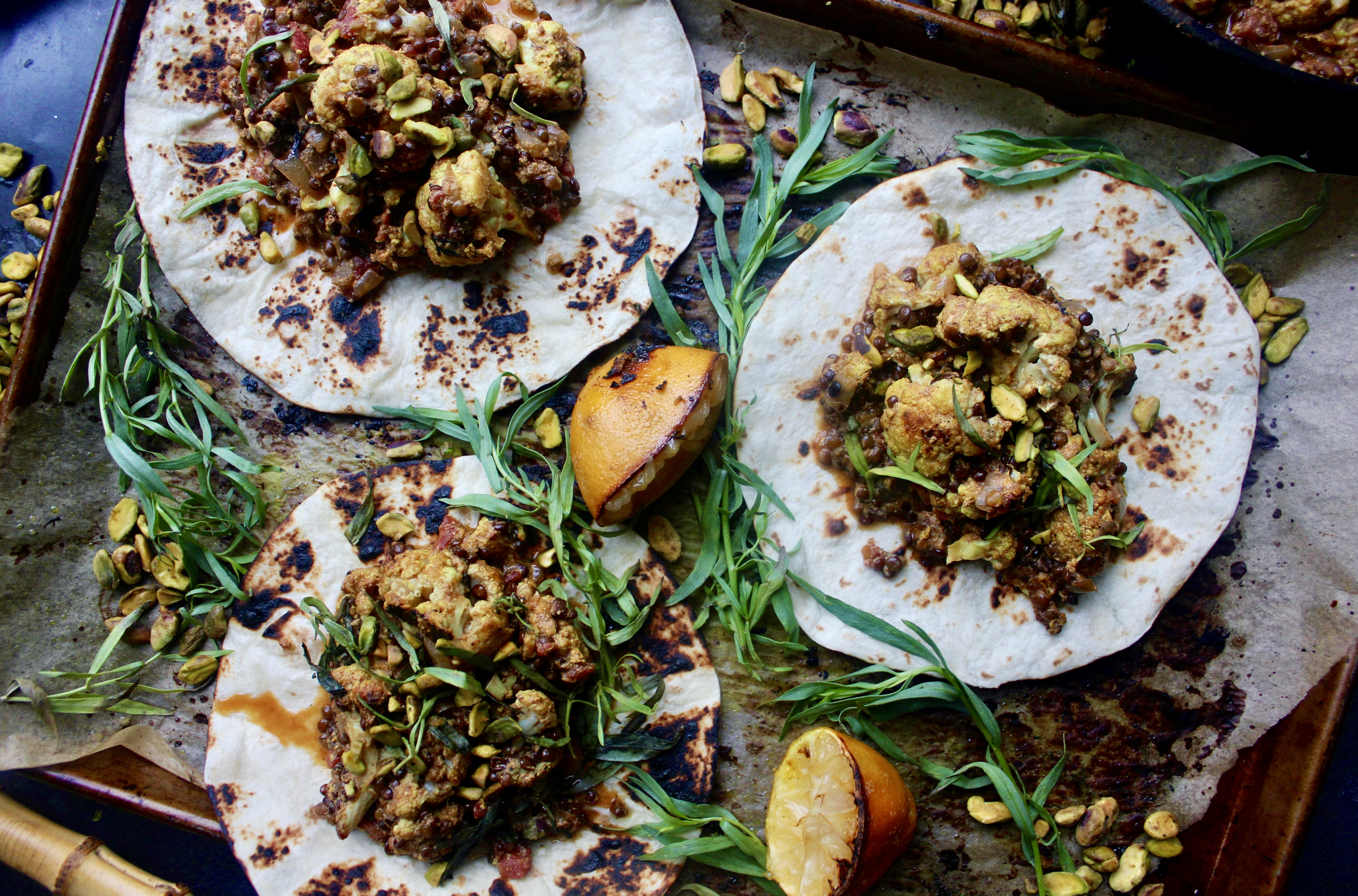 Crispy roasted cauliflower baked down with lentils in a cozy, spiced yellow curry ginger sauce: these Easy Cauliflower and Lentil Korma Tacos are the best weeknight comfort food.