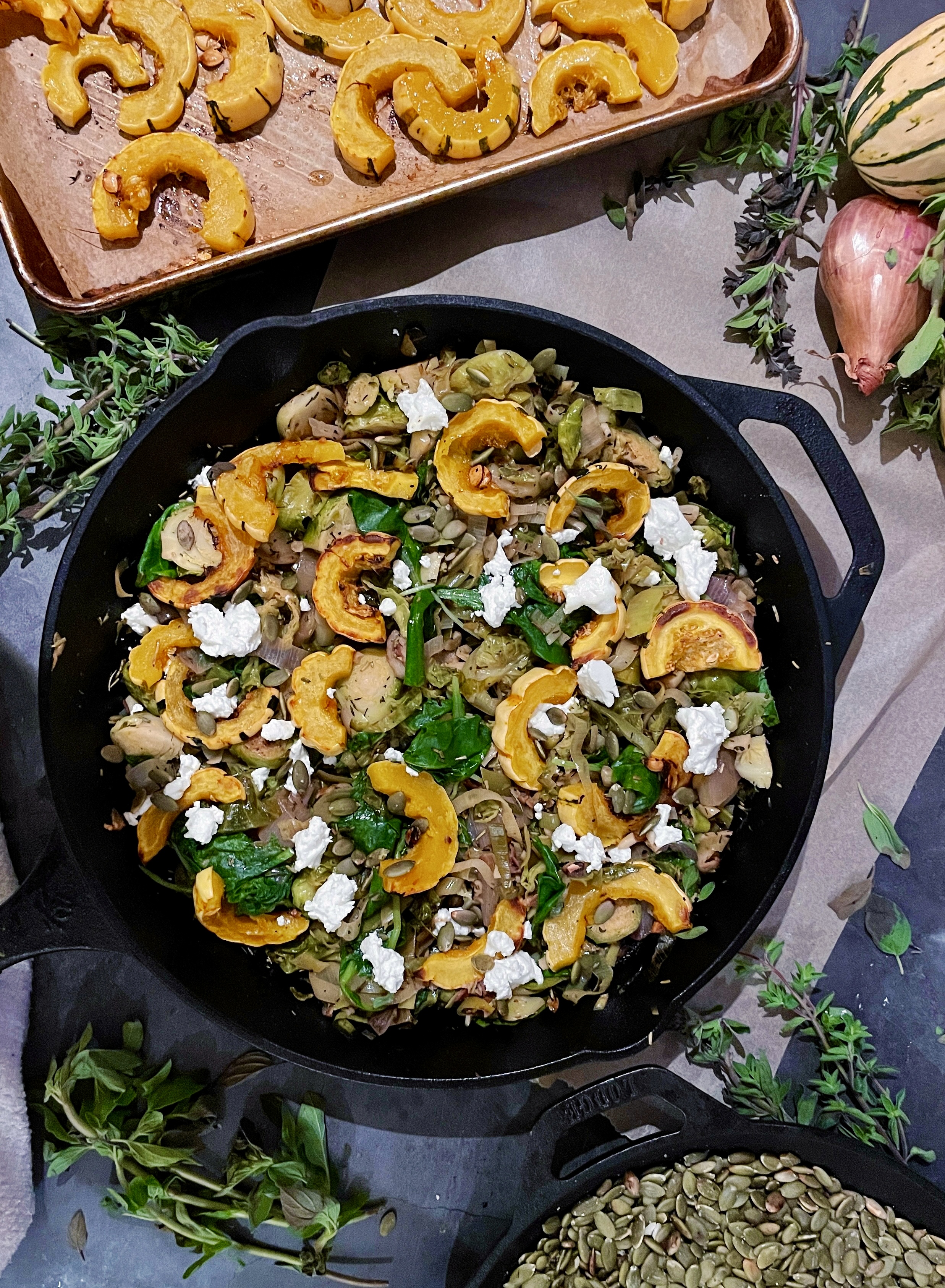 Perfectly charred roasted delicata squash with white wine apple cider wilted brussels sprouts and leeks all tossed up with some tuscan kale, creamy goat cheese, and crunchy pumpkin seeds: this Herbed Brussels, Leeks, and Roasted Delicata Squash Hash is my favorite way to use up all those fall veggies!!