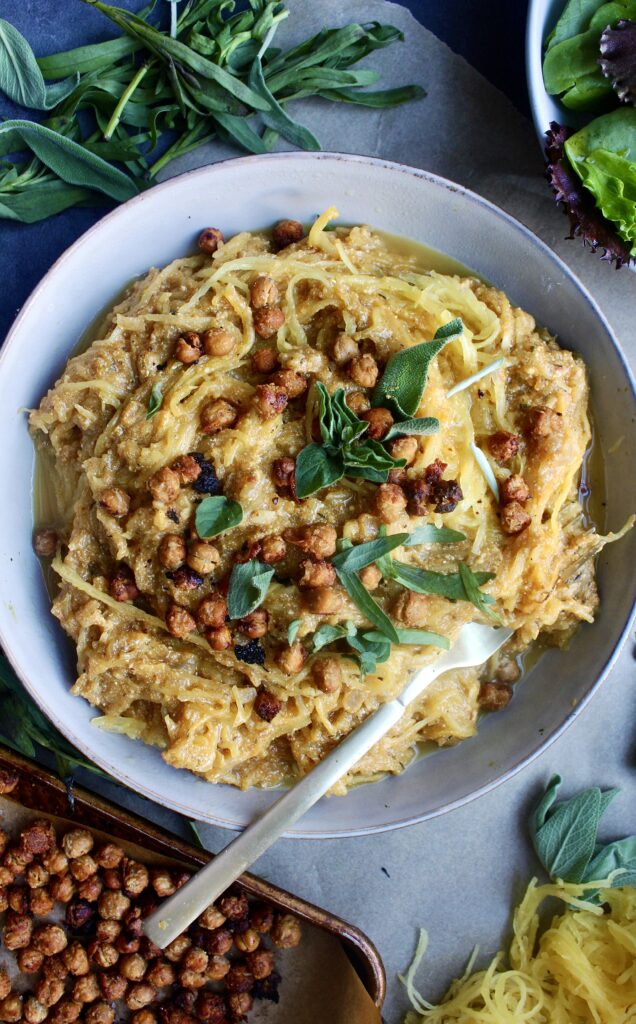 A creamy, lighter pumpkin vodka sauce tossed with perfectly roasted spaghetti squash topped with crispy chickpeas, all the herbs, and of course tons of ricotta: I could seriously eat this Pumpkin Ricotta Spaghetti Squash with Crispy Chickpeas every night of the week. 