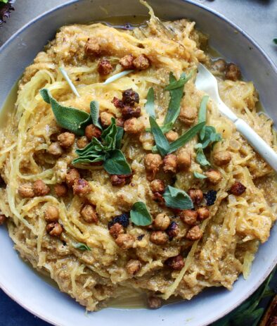 A creamy, lighter pumpkin vodka sauce tossed with perfectly roasted spaghetti squash topped with crispy chickpeas, all the herbs, and of course tons of ricotta: I could seriously eat this Pumpkin Ricotta Spaghetti Squash with Crispy Chickpeas every night of the week.