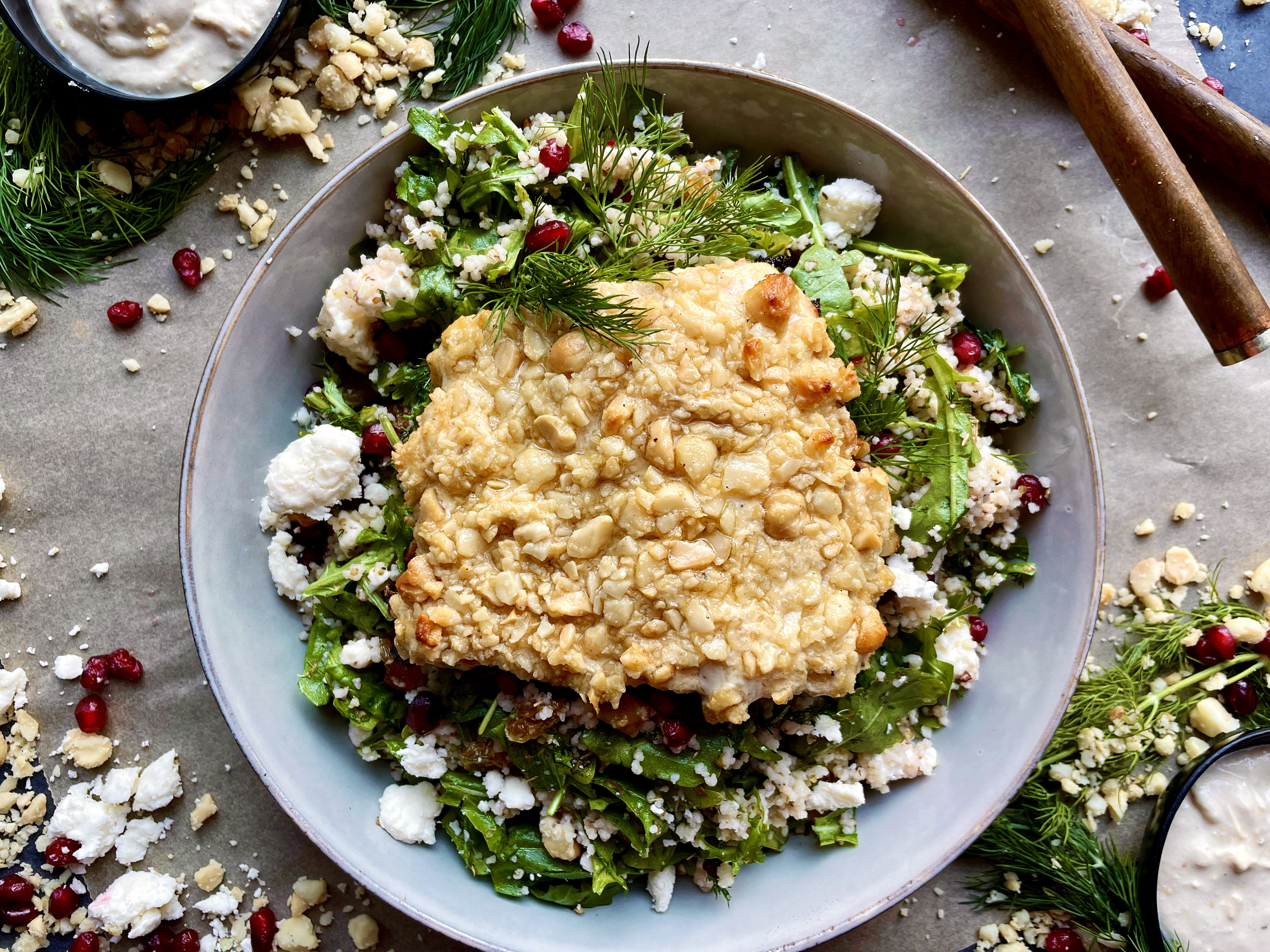 A dijon hummus and macadamia nut crusted salmon over a pomegranate feta pearled couscous salad: these Hummus Macadamia Crusted Salmon Couscous Bowls are one of my favorite healthy fall recipes!