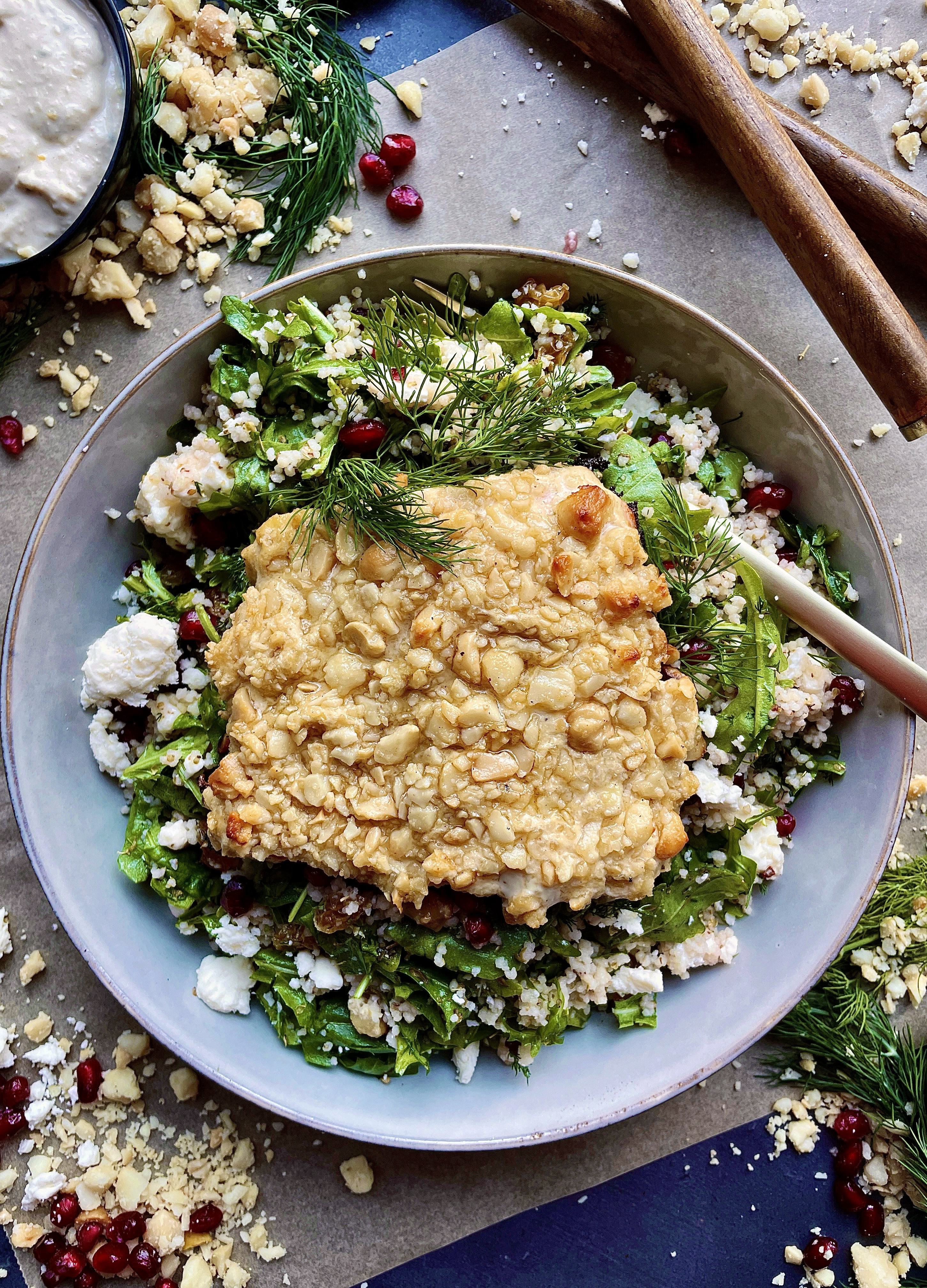 A dijon hummus and macadamia nut crusted salmon over a pomegranate feta pearled couscous salad: these Hummus Macadamia Crusted Salmon Couscous Bowls are one of my favorite healthy fall recipes!