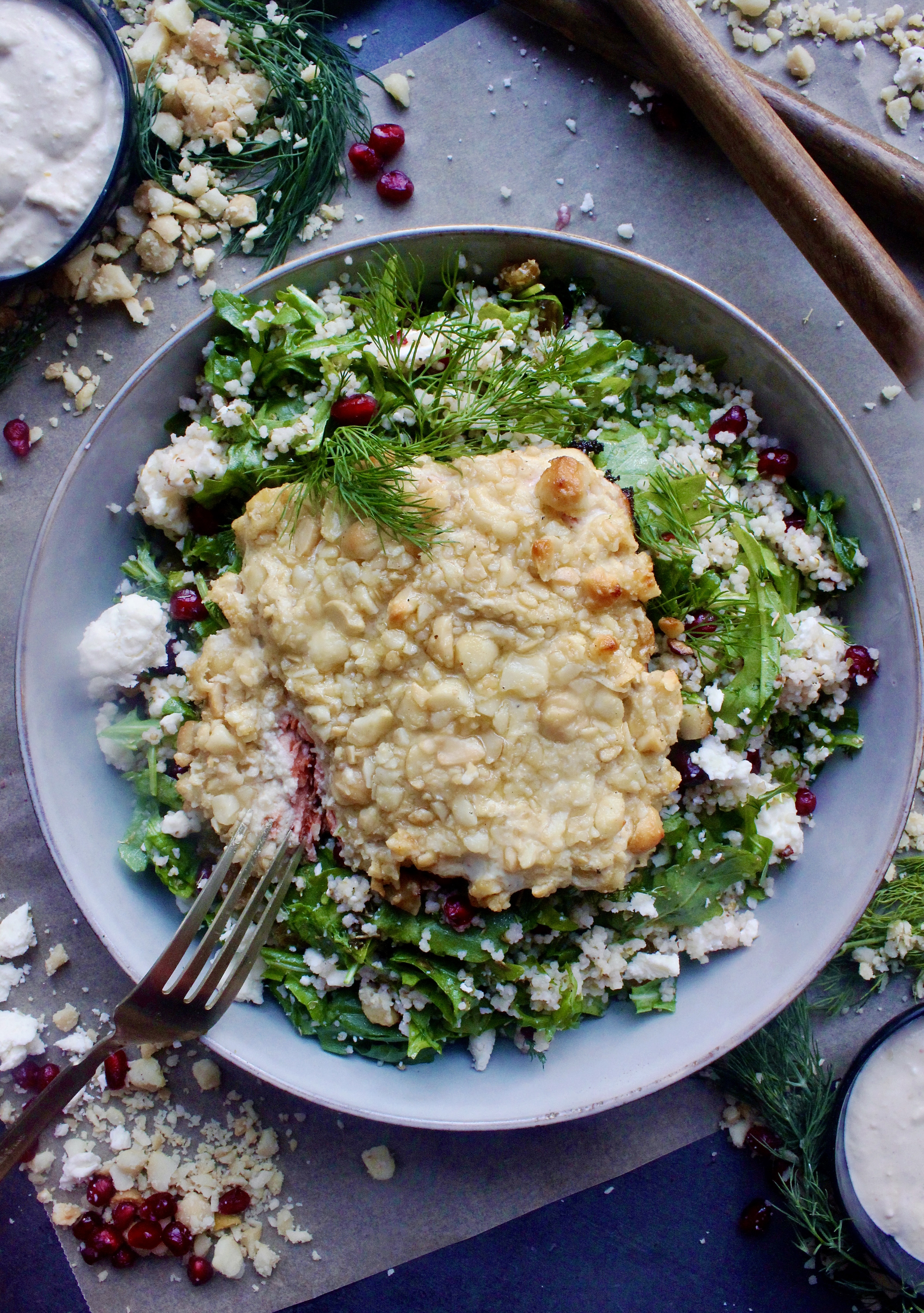 A dijon hummus and macadamia nut crusted salmon over a pomegranate feta pearled couscous salad: these Hummus Macadamia Crusted Salmon Couscous Bowls are one of my favorite healthy fall recipes!