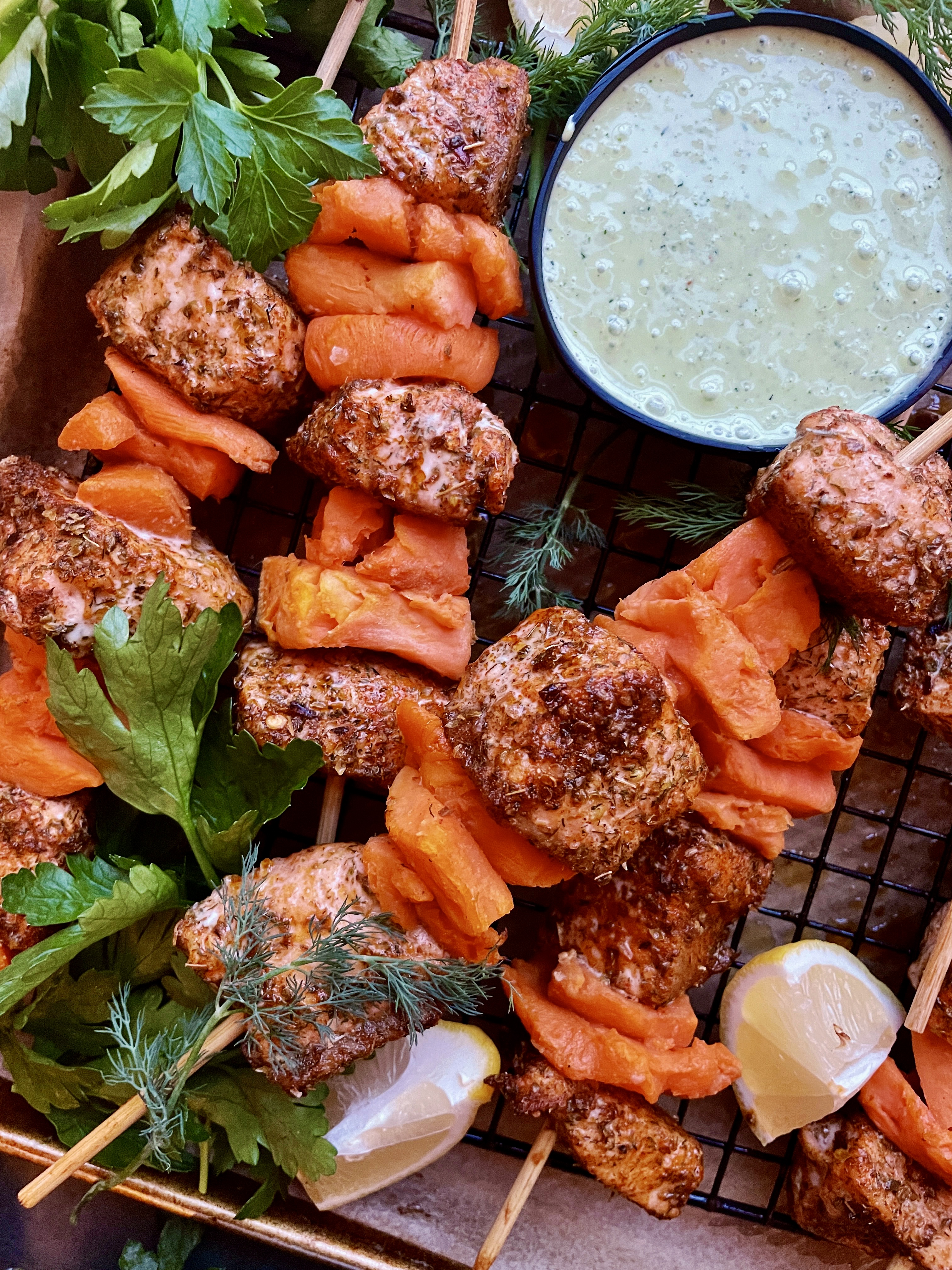 Crispy baked salmon layered with smashed sweet potato cubes and finished off with a lemony parsley dill yogurt: these Smashed Sweet Potato Salmon Skewers with Parsley Dill Sauce are an all time favorite recipe!