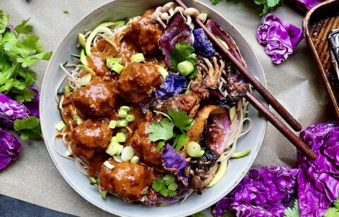 An extra creamy, warm peanut sauce spooned over the easiest baked meatball soba noodle bowl all topped off with crispy cabbage and mushrooms: these Thai Peanut Meatball Noodle Bowls with Crispy Cabbage are a burst of flavor!