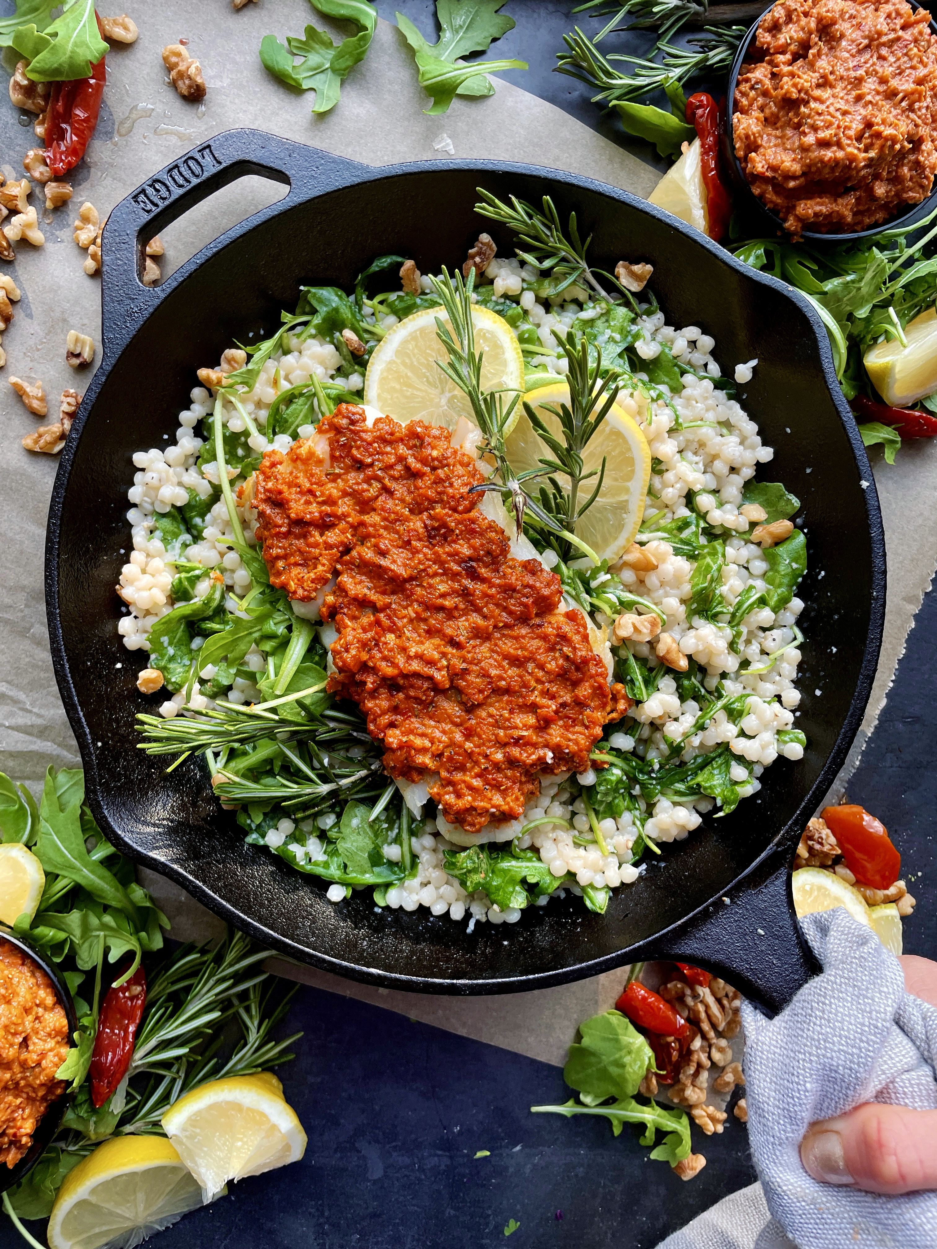 The easiest tangy spiced sun-dried tomato pesto spooned onto a crispy fillet of fish and served over a warm pearled couscous salad: this Crispy Sun-Dried Tomato Cod Over Lemony Couscous is one of my favorite fish recipes out there!