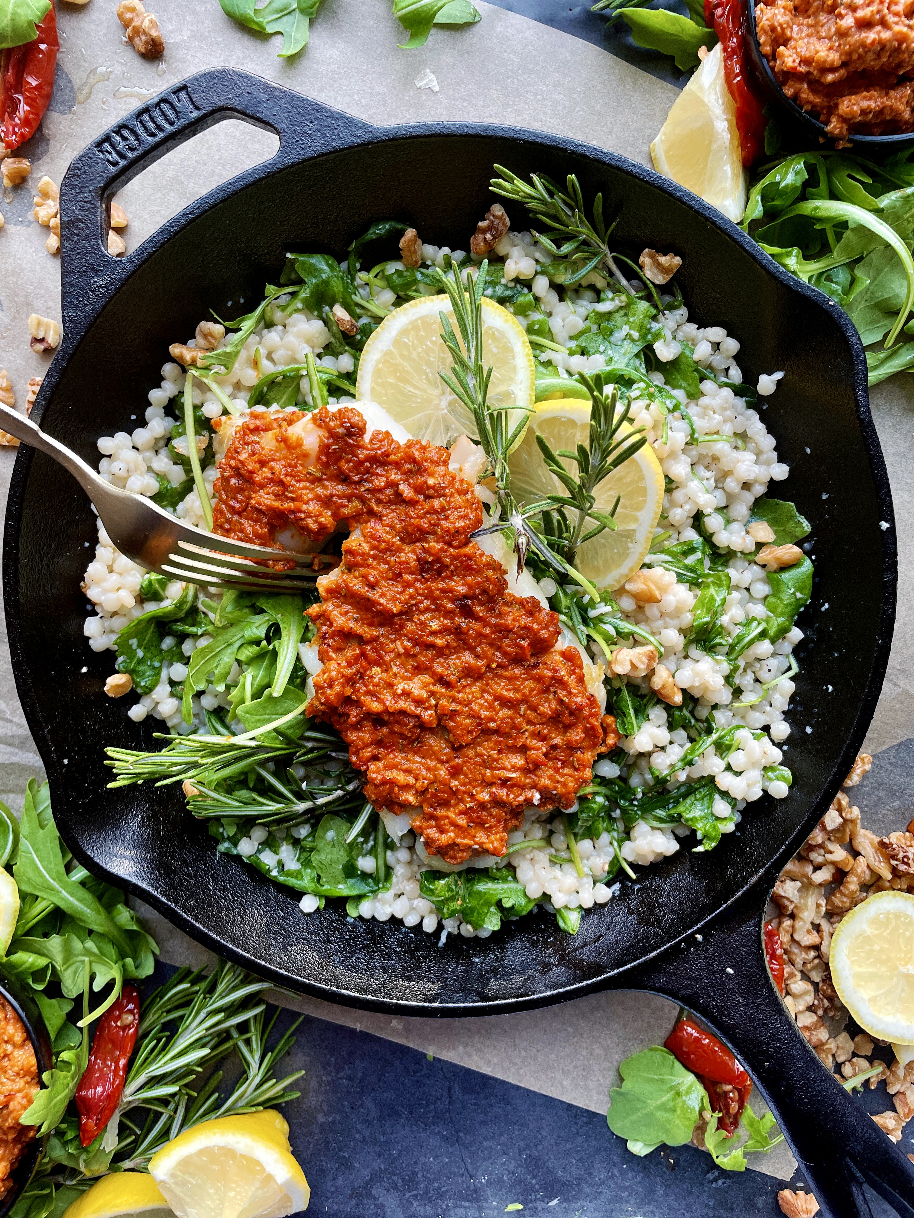 The easiest tangy spiced sun-dried tomato pesto spooned onto a crispy fillet of fish and served over a warm pearled couscous salad: this Crispy Sun-Dried Tomato Cod Over Lemony Couscous is one of my favorite fish recipes out there!