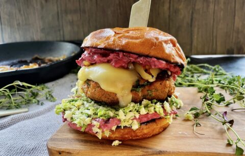 A creamy, tangy pancetta cranberry remoulade spread on a crispy pretzel bun with a brussels sprouts slaw, caramelized onions, and a melty juicy gouda turkey burger: these Cranberry Gouda Turkey Burgers with Caramelized Onions are the ultimate Christmas burger!!