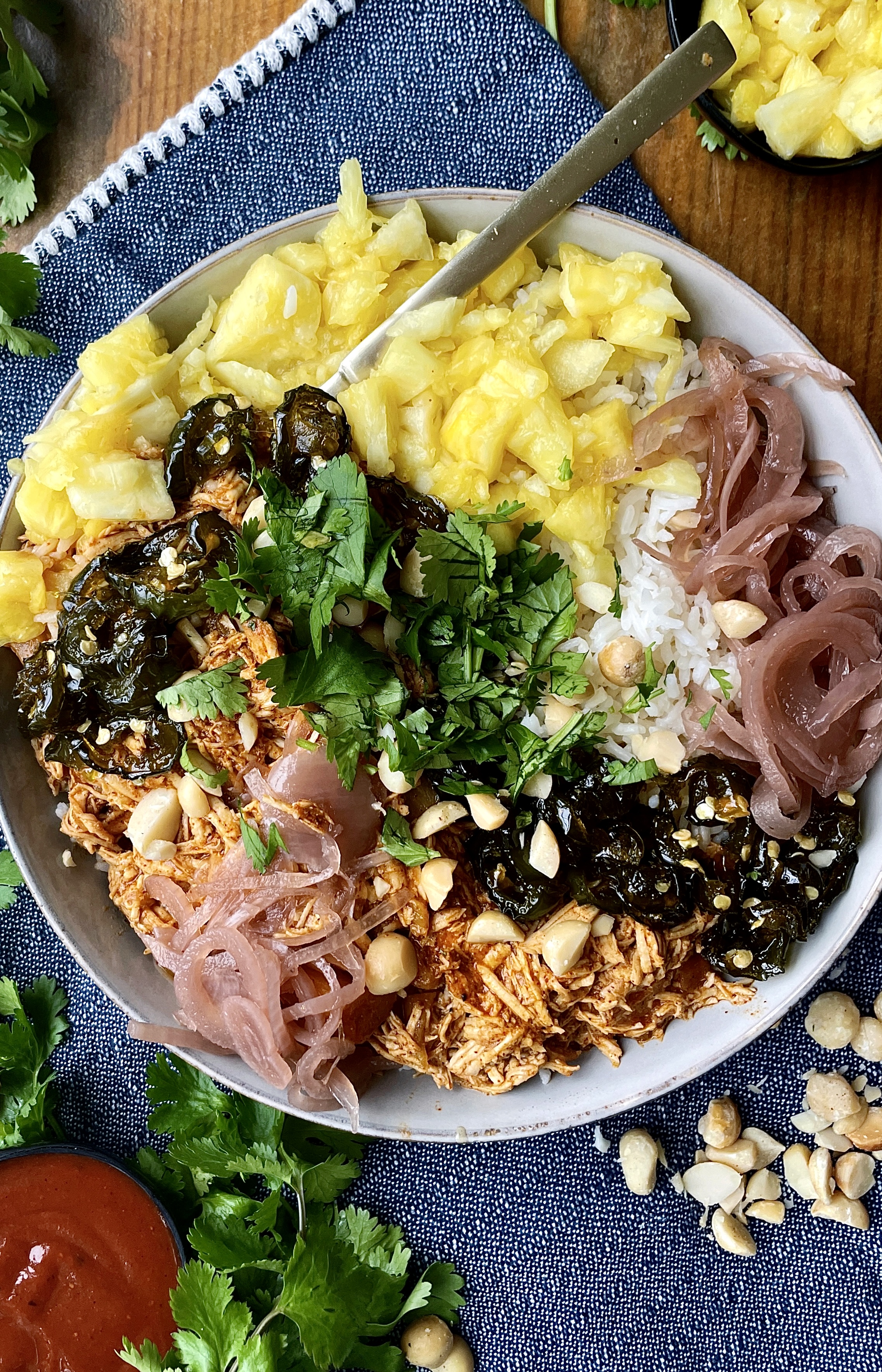 Juicy pineapple, beer, and bbq pulled chicken mixed up with Monterey Jack cheese, some easy hot honey jalapeños, and all the good sweet and tangy toppings: these Hot Honey Jalapeños Hawaiian BBQ Chicken Bowls are a burst of fresh flavor!