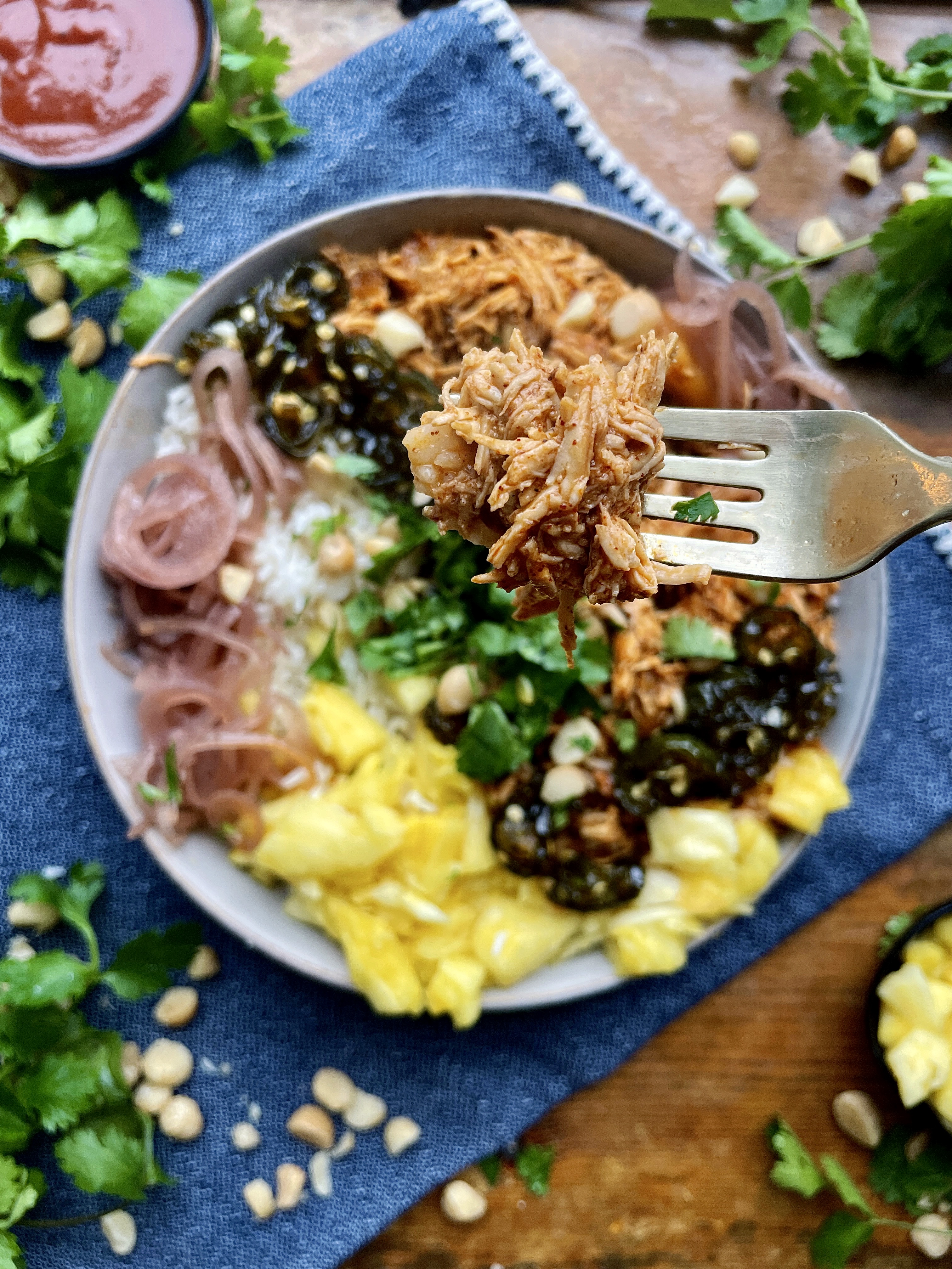 Juicy pineapple, beer, and bbq pulled chicken mixed up with Monterey Jack cheese, some easy hot honey jalapeños, and all the good sweet and tangy toppings: these Hot Honey Jalapeños Hawaiian BBQ Chicken Bowls are a burst of fresh flavor!