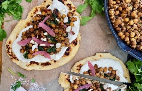 Crispy, crunchy chickpeas toasted in mango chutney and all the good Indian spices wilted down with some garlicky spinach and served over a layer of a salty fresh yogurt sauce and warm naan: these Indian Chickpea Naan Flatbreads with Cucumber Feta Crema are truly a bite of heaven.