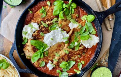 Crispy, lightly seared chicken breasts tucked into a lightened up vodka sauce all finished off in the oven and topped with creamy burrata and pesto: this Skillet Vodka Sauce Chicken Parmesan with Burrata is truly a death row meal.
