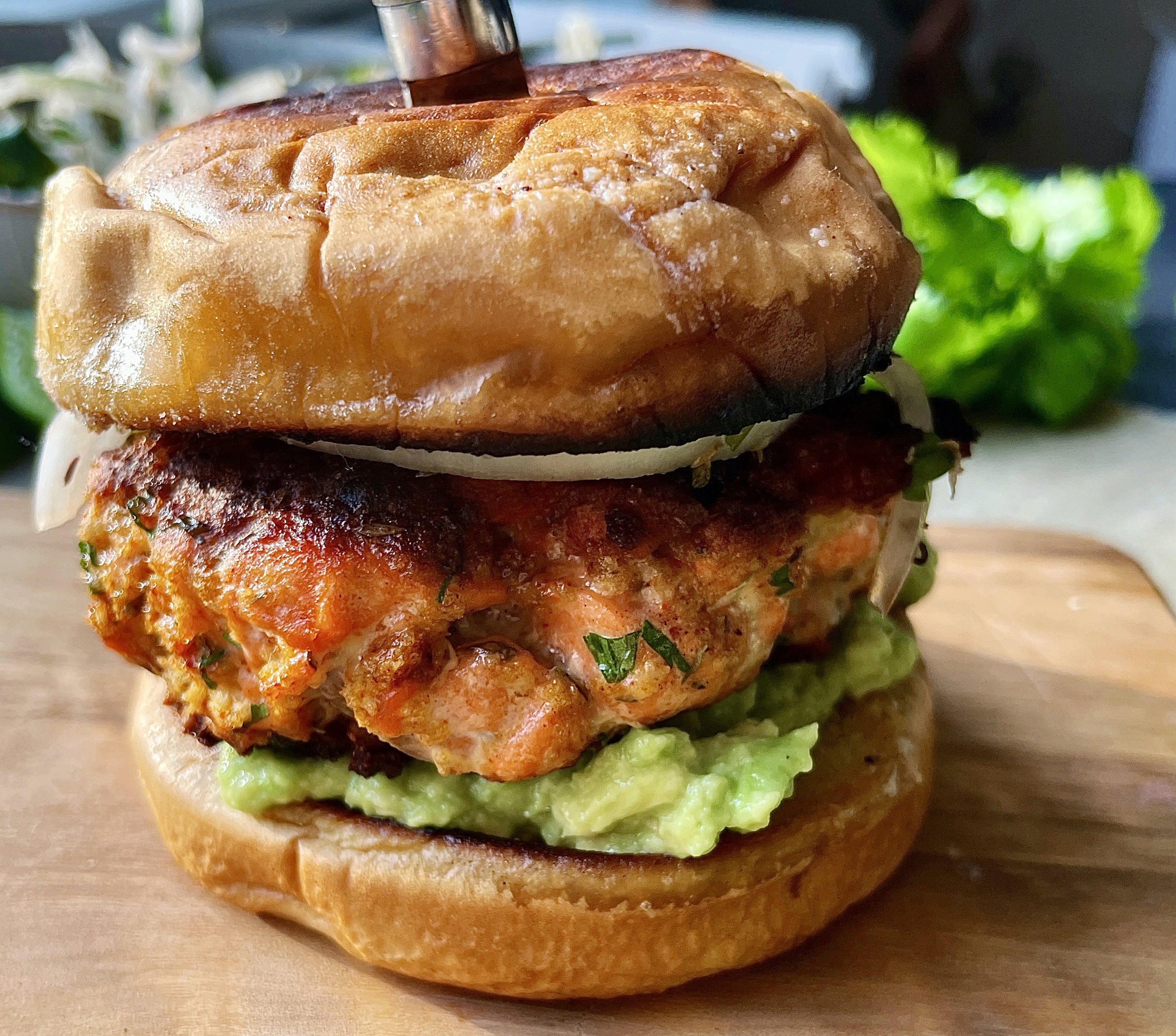 Crispy, juicy, and slightly tangy salmon patties layered over an easy avocado mash and cilantro marinated onions: these Zesty Avocado Cilantro Salmon Burgers are truly a game-changing dinner.