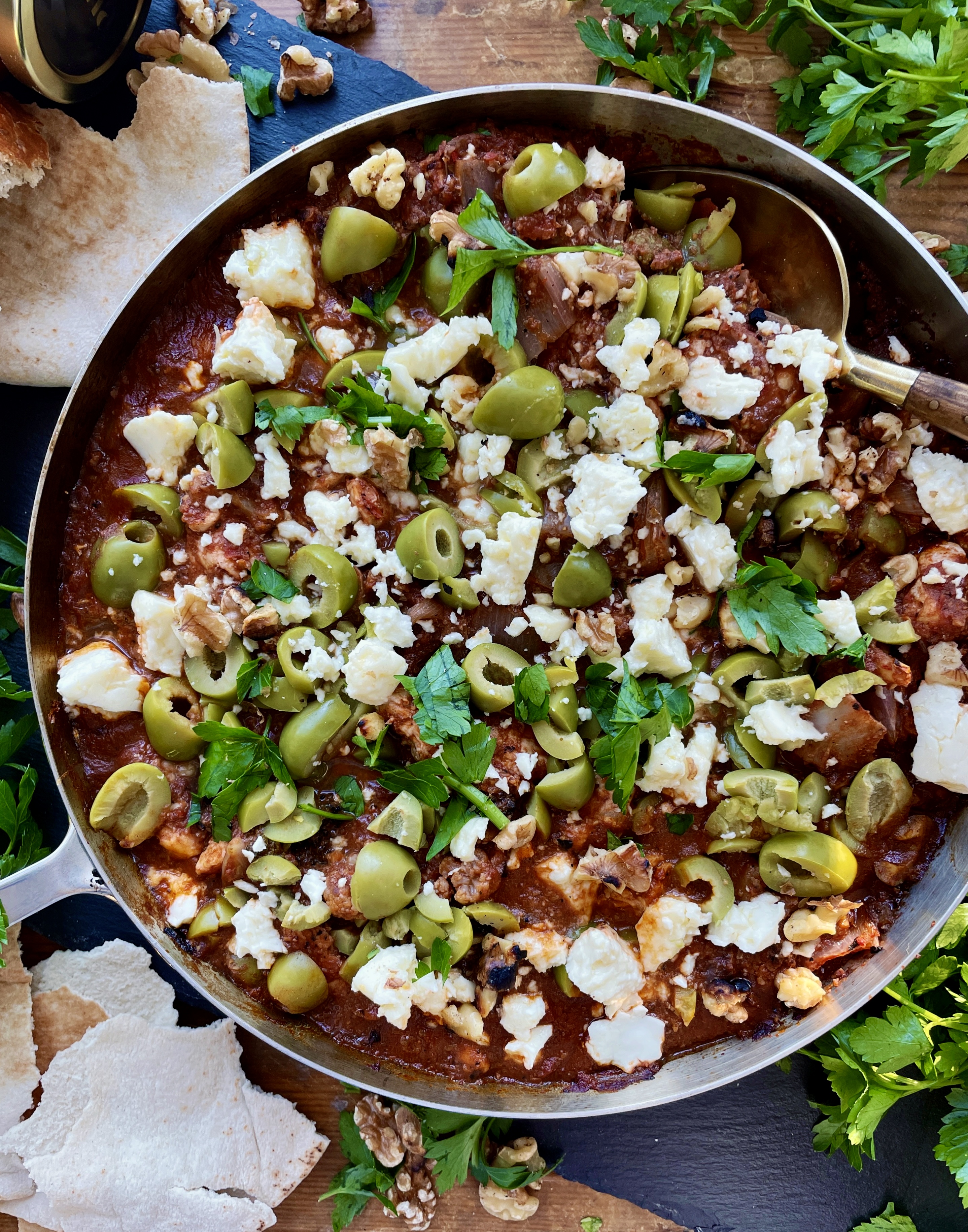 Crispy charred chicken and cauliflower sautéed up in a garlicky fire roasted tomato paste finished off with creamy feta cheese and castelvetrano olives: this Feta Olive and Walnut Chicken Skillet is a fav easy weeknight dinner!