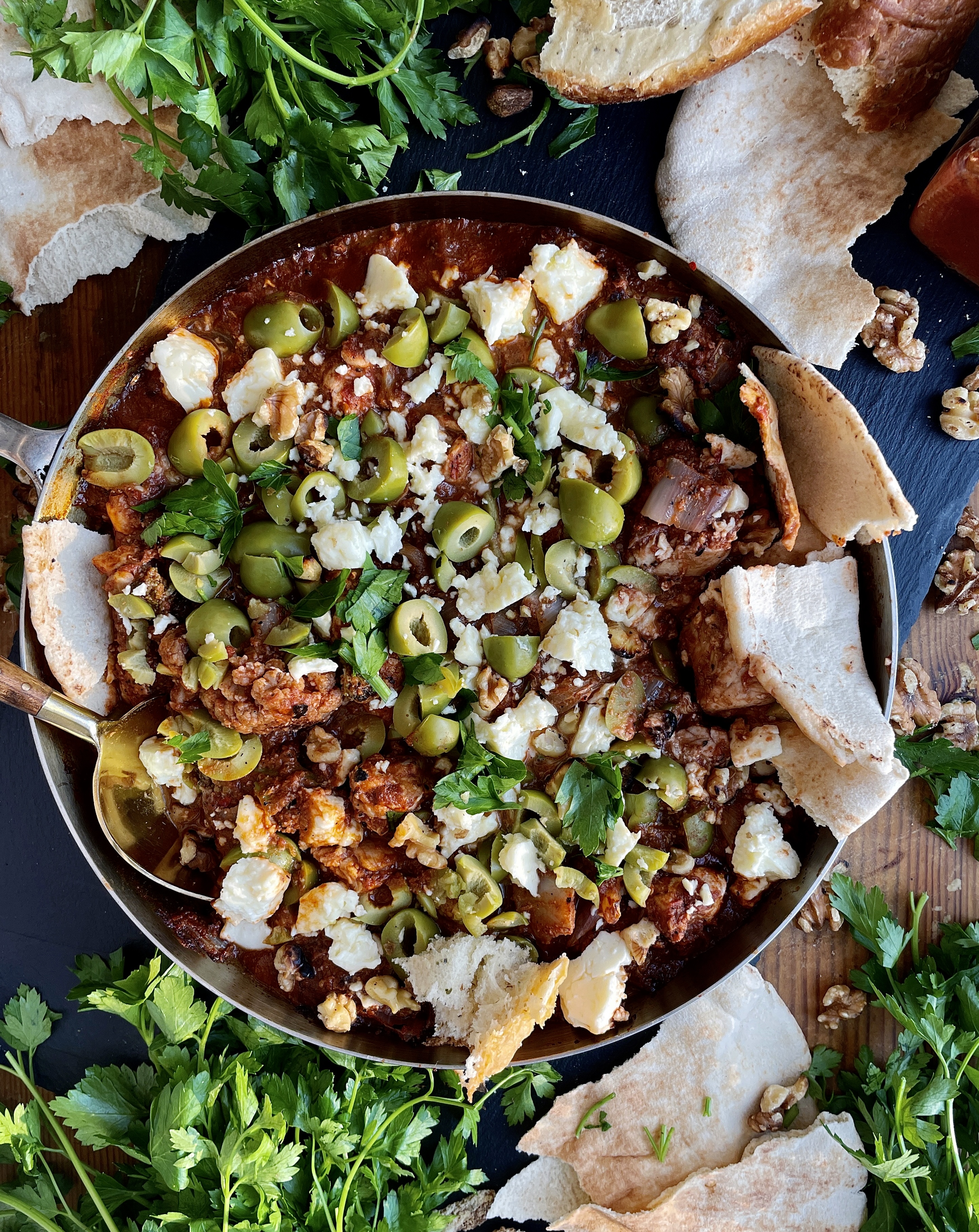 Crispy charred chicken and cauliflower sautéed up in a garlicky fire roasted tomato paste finished off with creamy feta cheese and castelvetrano olives: this Feta Olive and Walnut Chicken Skillet is a fav easy weeknight dinner!