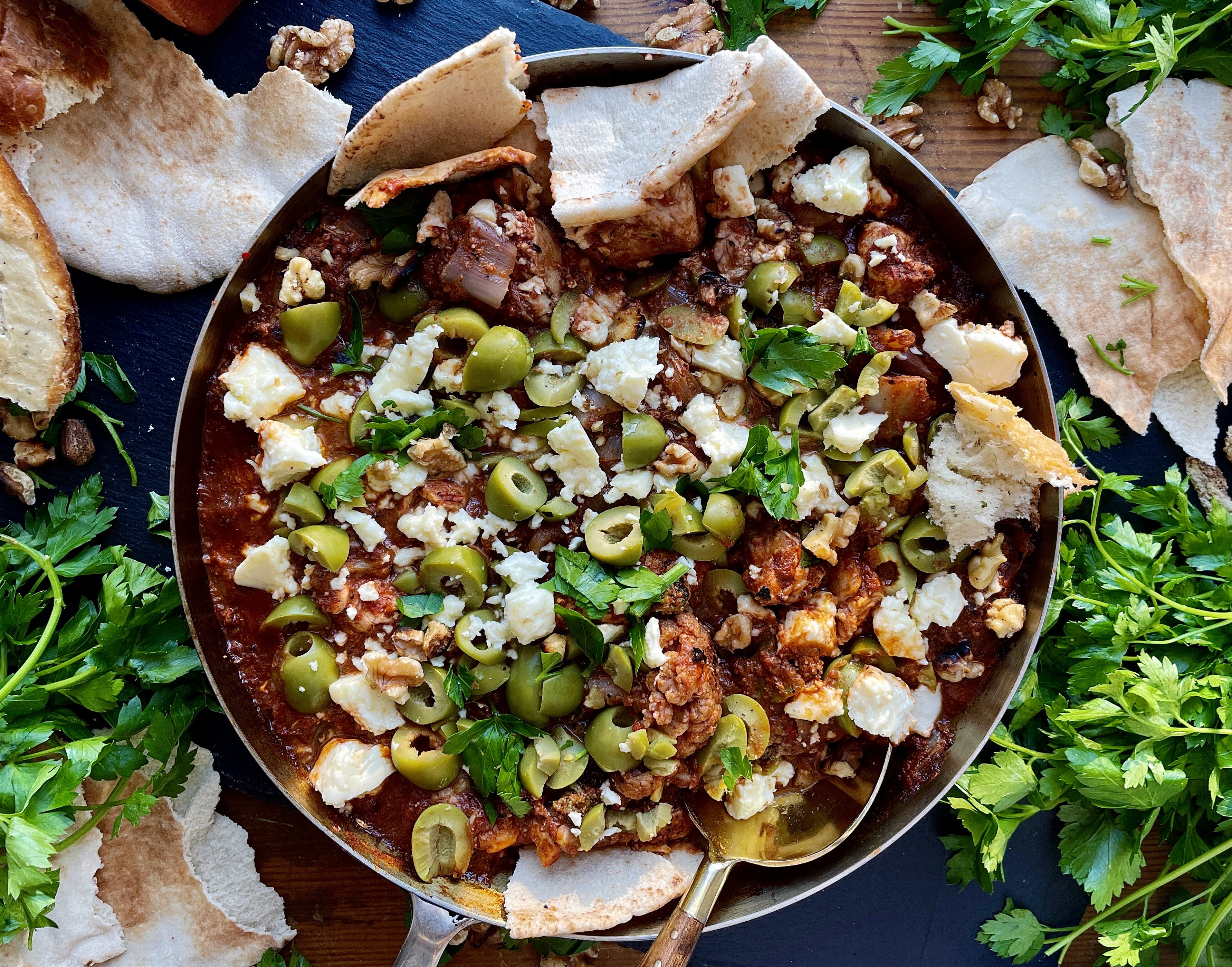 Crispy charred chicken and cauliflower sautéed up in a garlicky fire roasted tomato paste finished off with creamy feta cheese and castelvetrano olives: this Feta Olive and Walnut Chicken Skillet is a fav easy weeknight dinner!