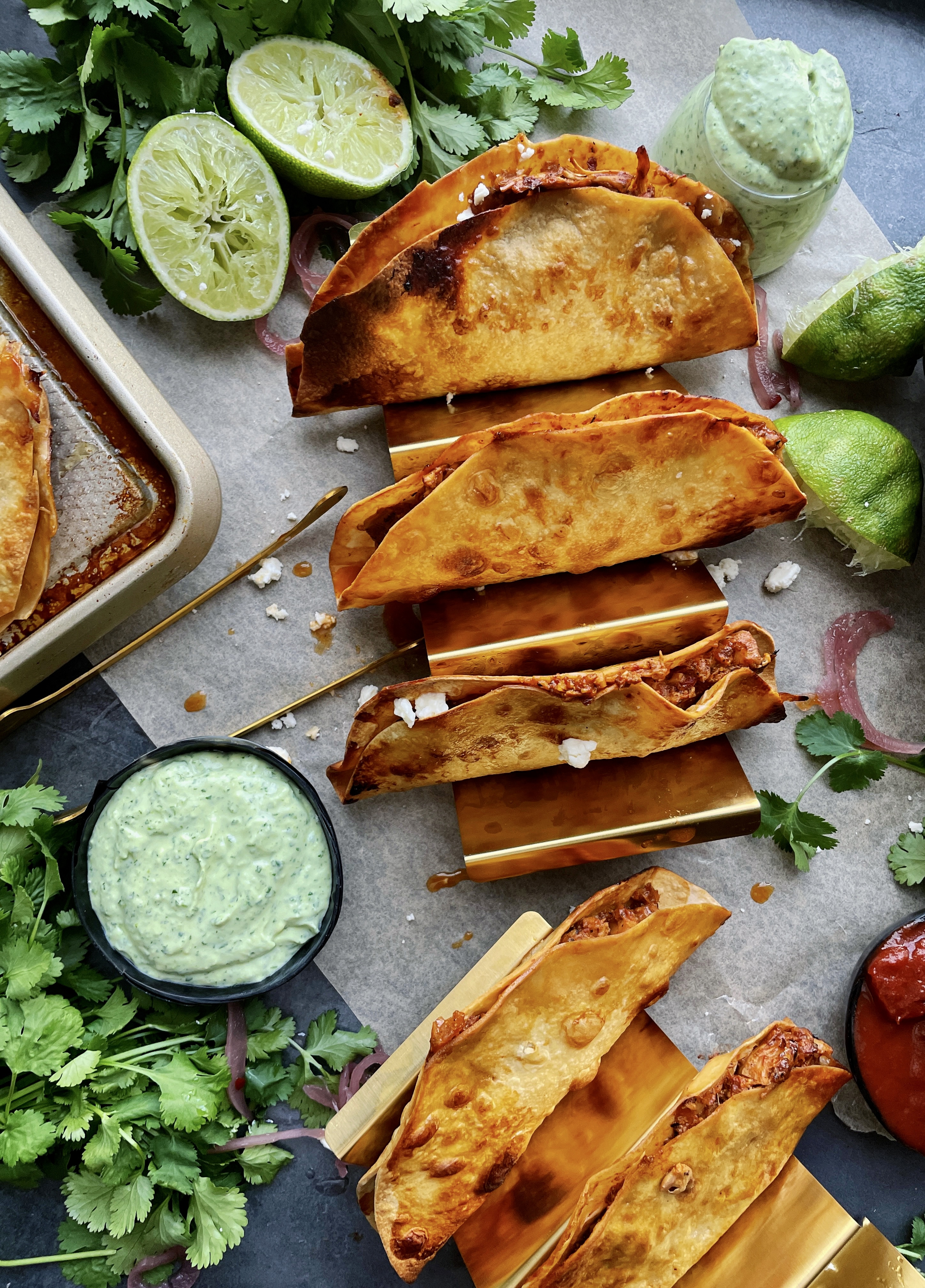  Homemade, golden crispy taco shells stuffed with adobo pulled chicken and jackfruit baked to perfection with all the melty cheese and dipped in a cooling avocado cilantro sauce: these Crispy Chicken and Jackfruit Tinga Tacos with Avocado Crema are truly a heavenly bite.