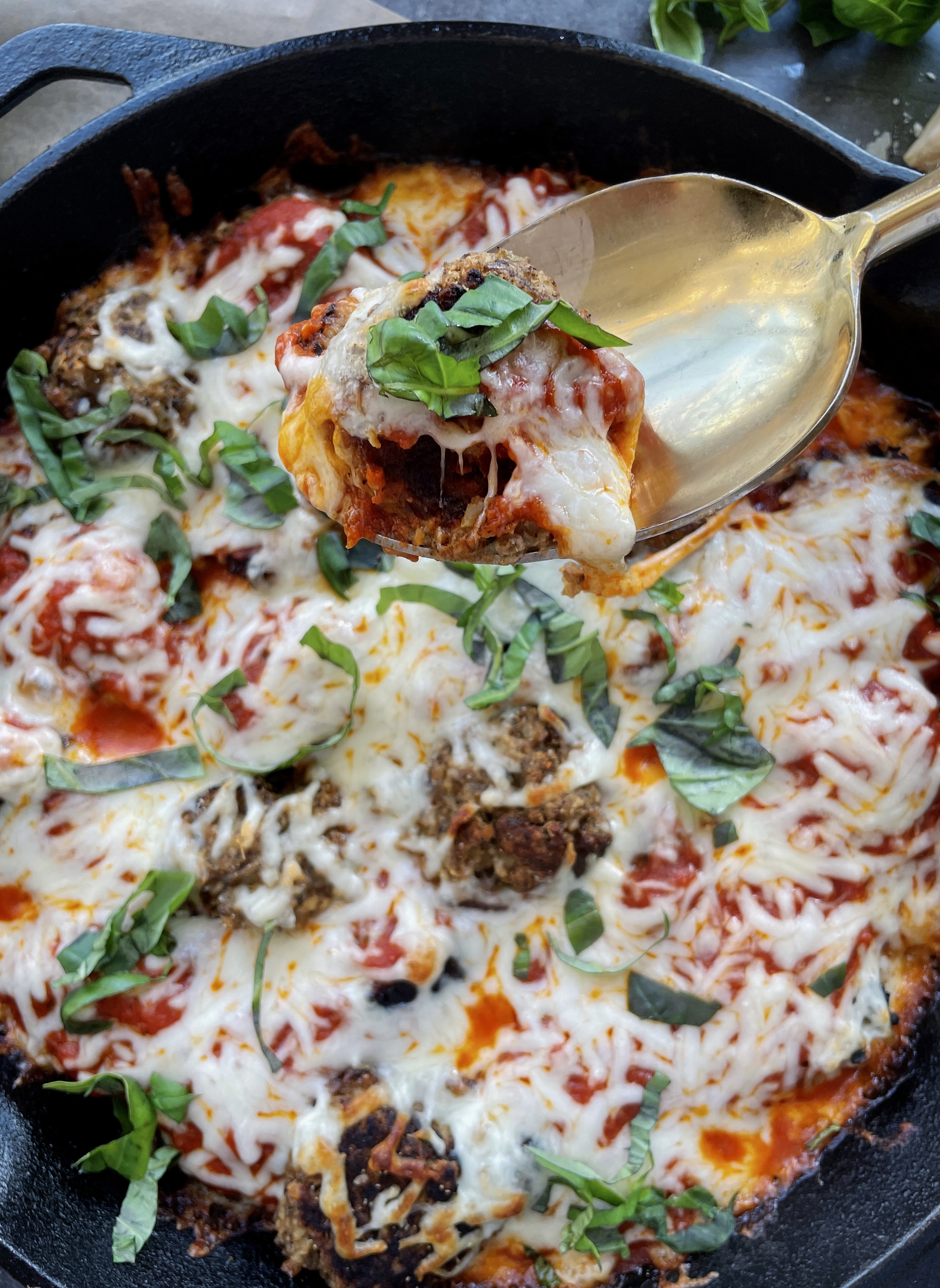 Lightly seared, veggie-filled, and protein-packed vegetarian meatballs baked off in marinara and all the cheese: this Cheesy Lentil Vegetarian "Meatball" Skillet is my favorite meatless weeknight dinner!