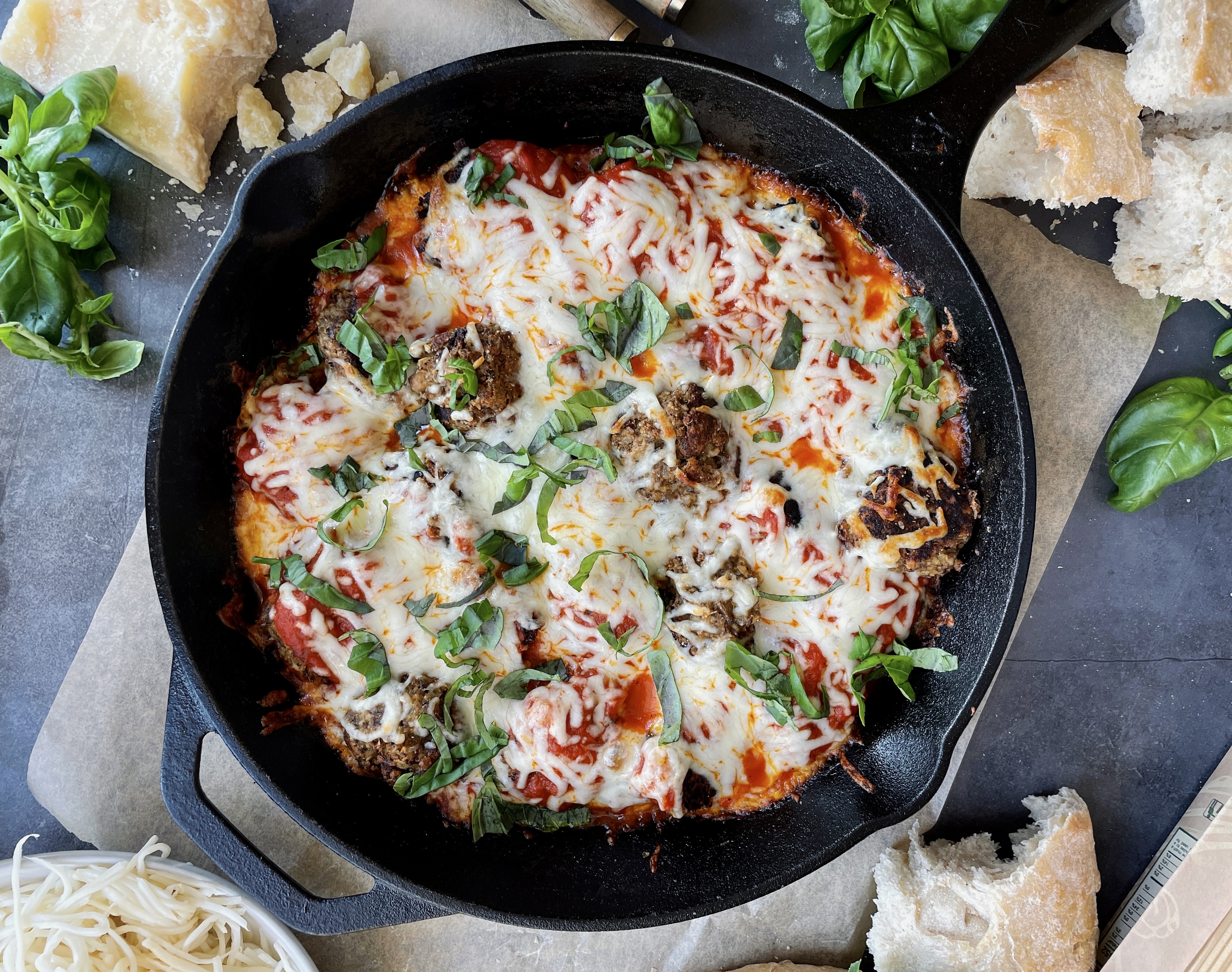 Lightly seared, veggie-filled, and protein-packed vegetarian meatballs baked off in marinara and all the cheese: this Cheesy Lentil Vegetarian "Meatball" Skillet is my favorite meatless weeknight dinner!