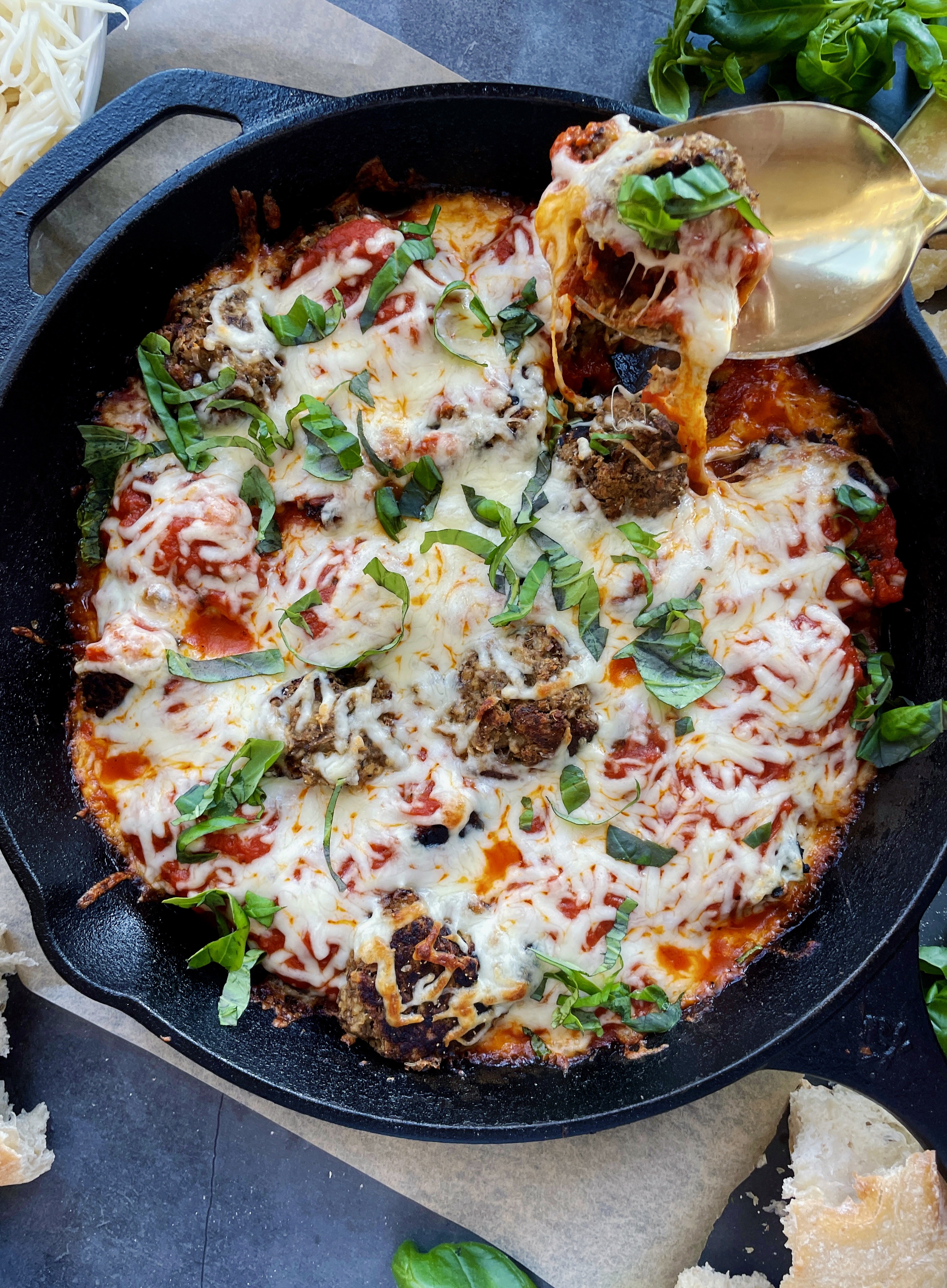 Lightly seared, veggie-filled, and protein-packed vegetarian meatballs baked off in marinara and all the cheese: this Cheesy Lentil Vegetarian "Meatball" Skillet is my favorite meatless weeknight dinner!