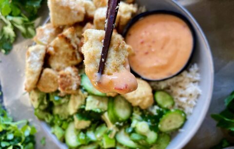 The crispiest oven roasted tofu clusters covered in the best ever sweet and spicy sauce and served alongside tangy marinated avocados and cucumbers: these Sweet Chili Crispy Torn Tofu Bowls recipe is truly the Asian bowl of my dreams!