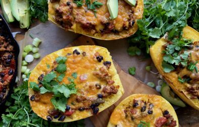 Warming spices mixed up in sautéed veggies, beans, tangy chiles, and all the cheese cooked down in a tomato sauce and tucked into roasted spaghetti squash boats: these Mexican Cheesy Bean and Turkey Spaghetti Squash Boats are everyone’s favorite dinner!