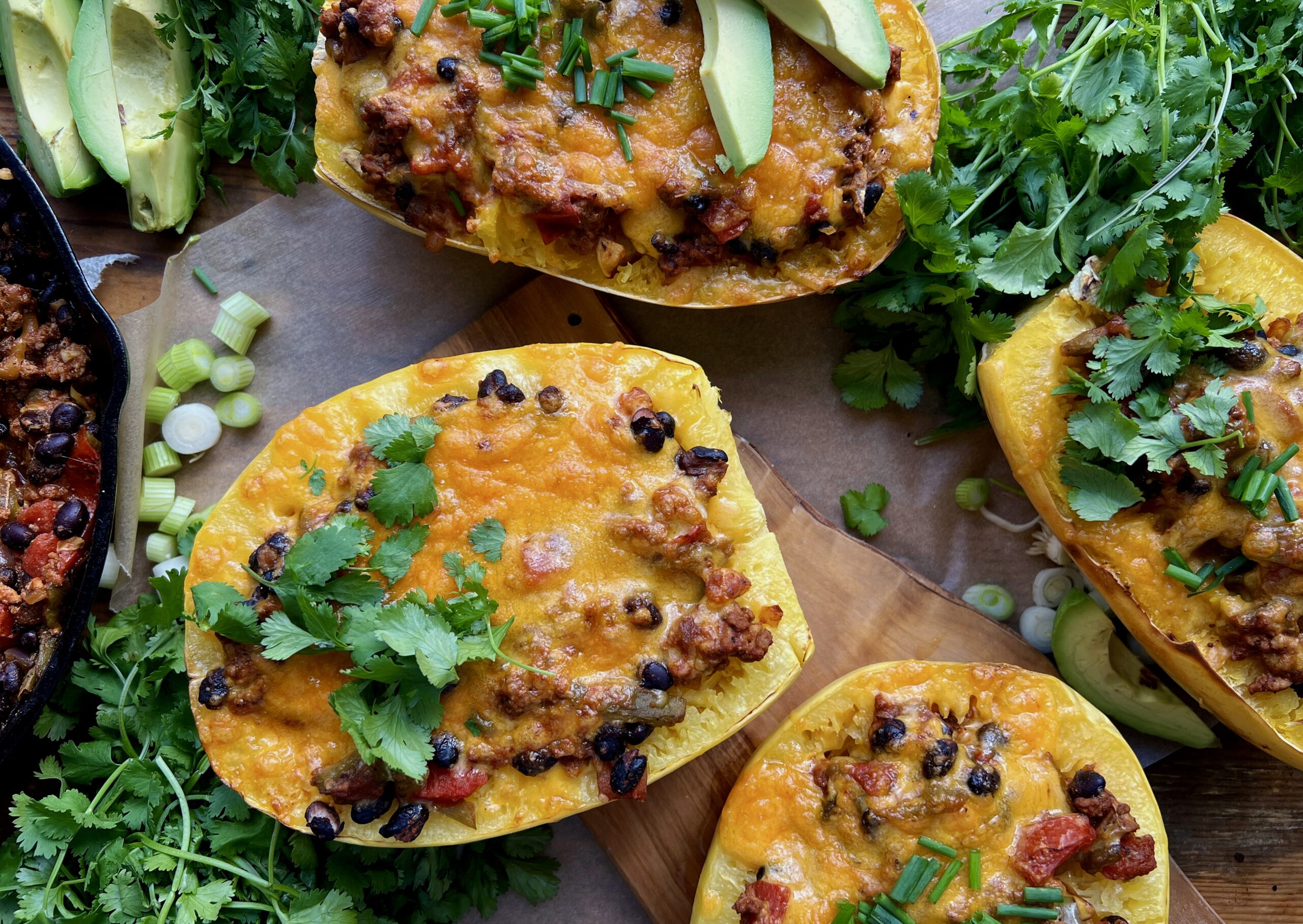 Warming spices mixed up in sautéed veggies, beans, tangy chiles, and all the cheese cooked down in a tomato sauce and tucked into roasted spaghetti squash boats: these Mexican Cheesy Bean and Turkey Spaghetti Squash Boats are everyone’s favorite dinner!