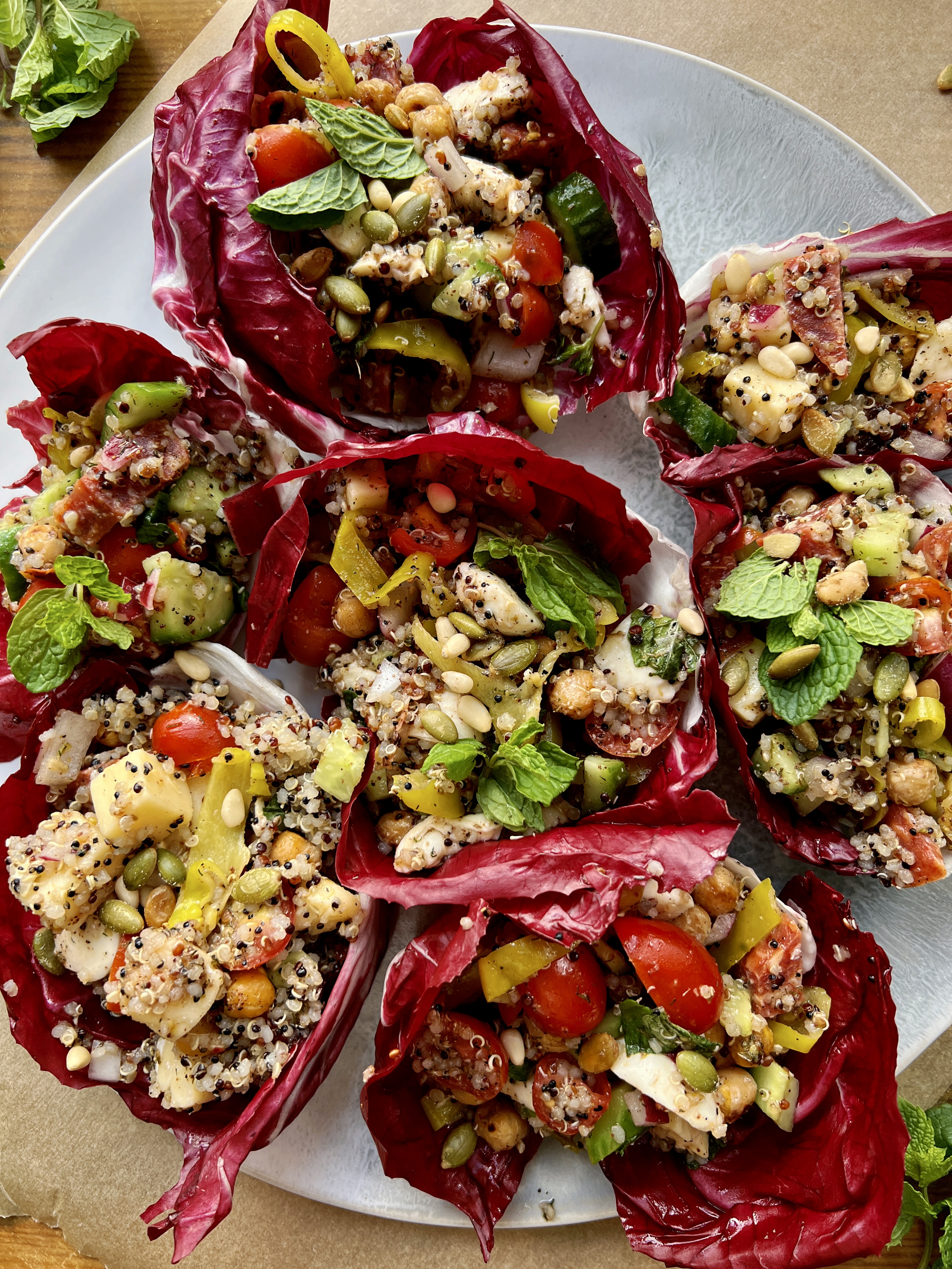 All the best fresh, Italian ingredients stuffed into some bitter, bright purple radicchio with quinoa, double the cheese, and so much flavor: these LA Chop Quinoa Radicchio Wraps are the perfect healthy lunch or dinner!