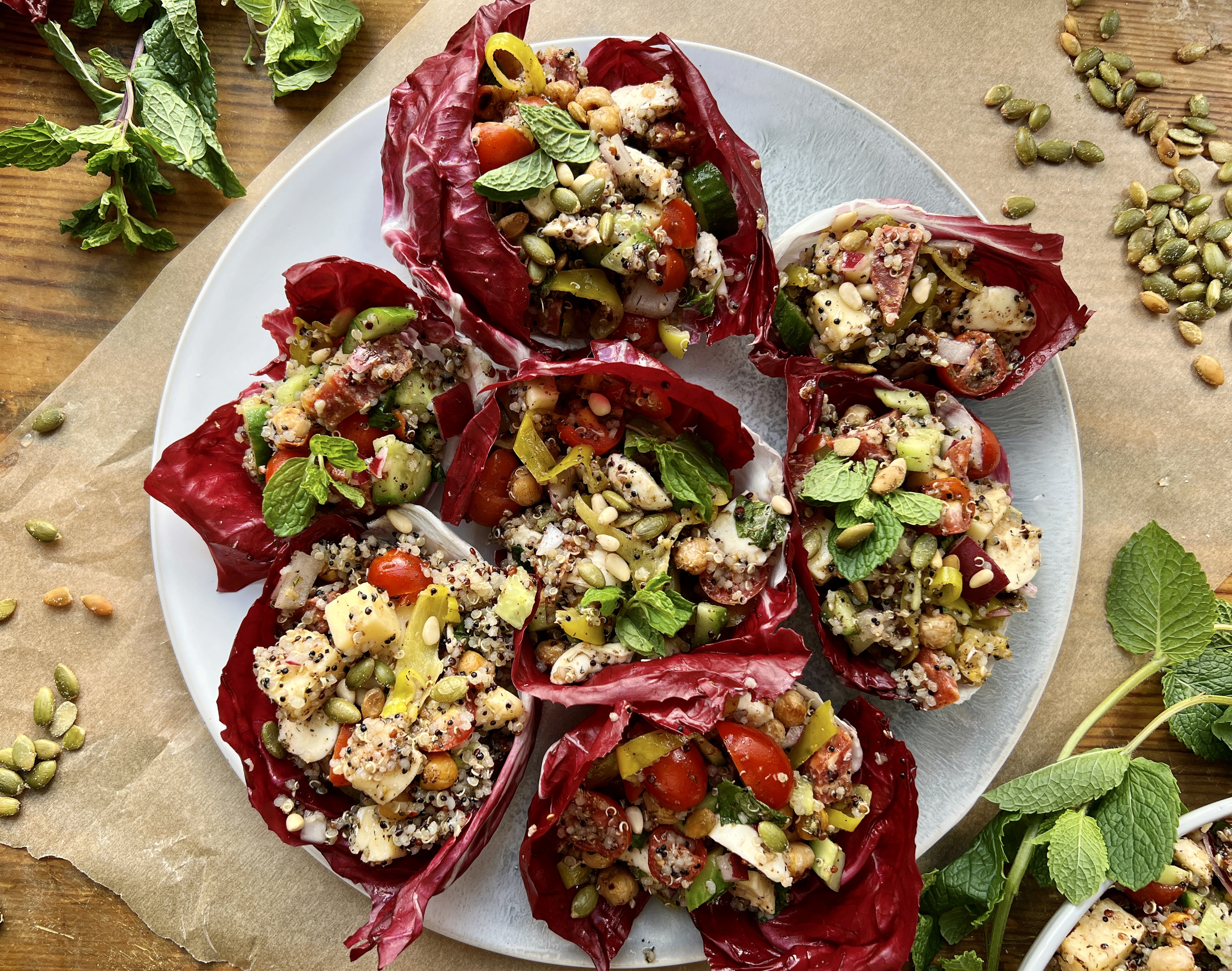 All the best fresh, Italian ingredients stuffed into some bitter, bright purple radicchio with quinoa, double the cheese, and so much flavor: these LA Chop Quinoa Radicchio Wraps are the perfect healthy lunch or dinner!