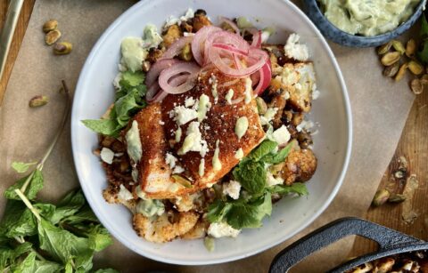 Crispy seared and roasted cauliflower florets tossed up in the most flavorful spice blend topped with flaky fish and a crunchy creamy avocado walnut herb blend: these Avocado Chimichurri Fish Taco Cauliflower Bowls truly are a burst of flavor!