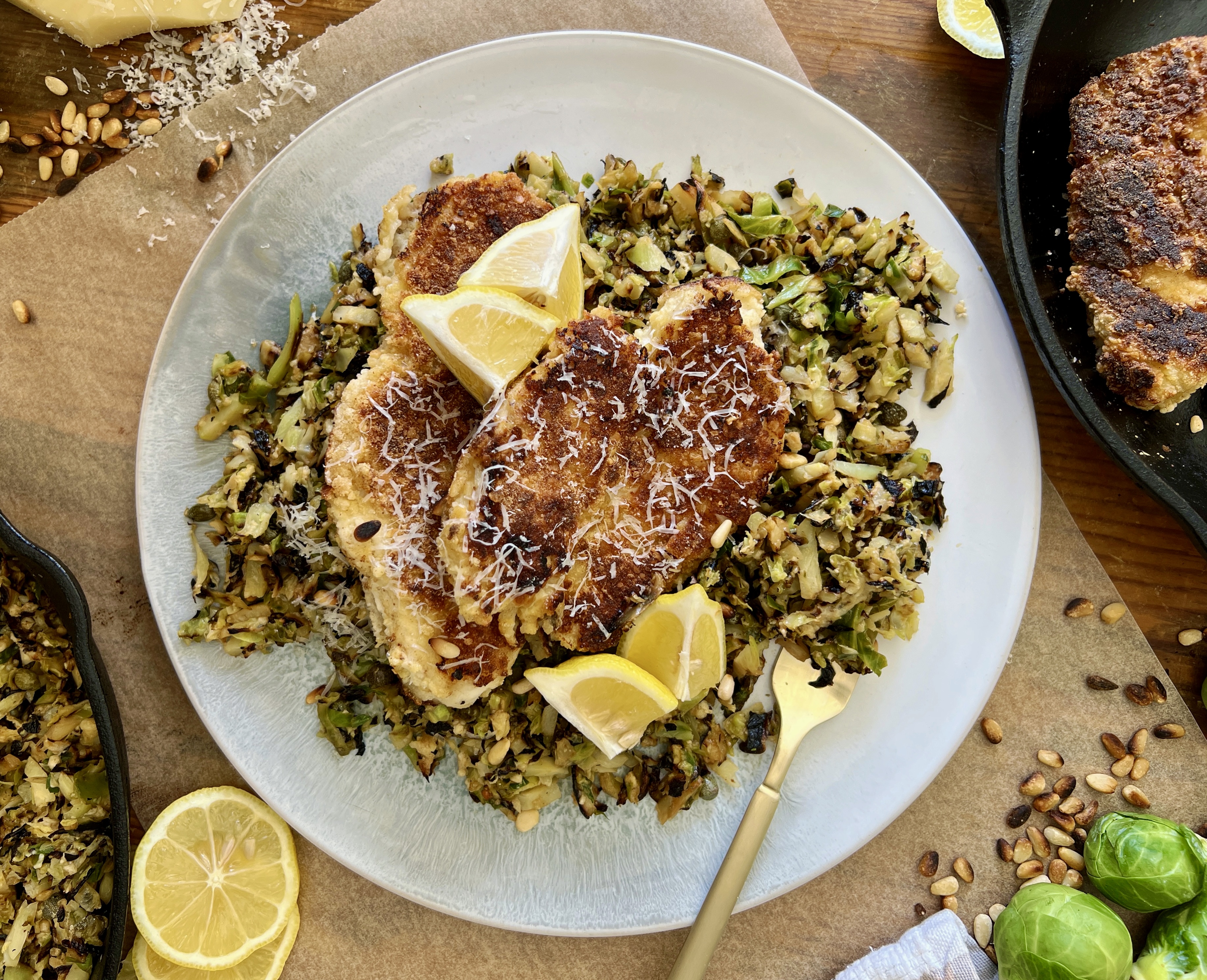  Juicy marinated, golden seared chicken on a simple parmesan briney brussels hash: this Crispy Chicken Over Lemon Caper Brussels is a burst of flavor!