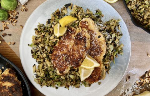 Juicy marinated, golden seared chicken on a simple parmesan briney brussels hash: this Crispy Chicken Over Lemon Caper Brussels is a burst of flavor!