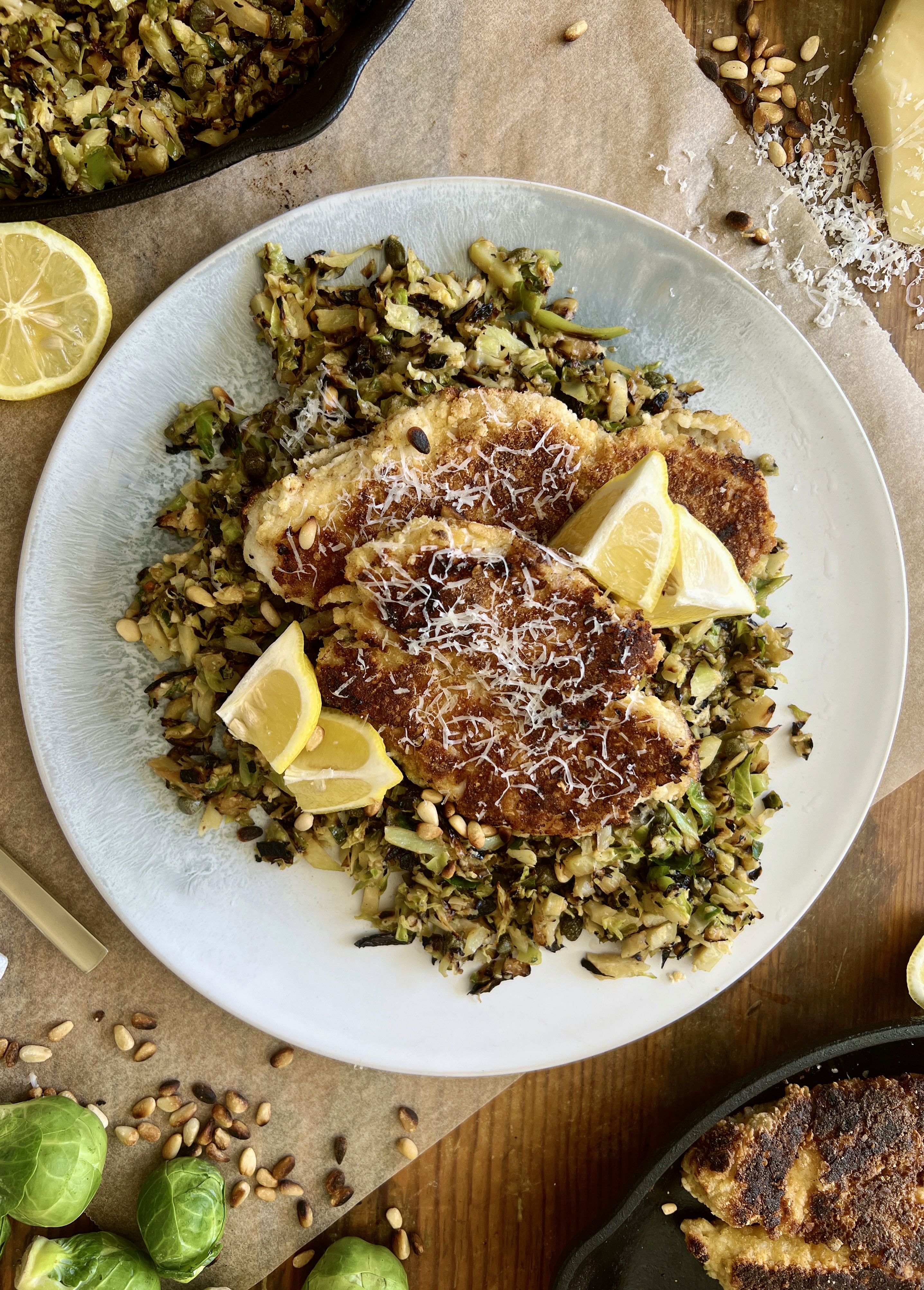  Juicy marinated, golden seared chicken on a simple parmesan briney brussels hash: this Crispy Chicken Over Lemon Caper Brussels is a burst of flavor!