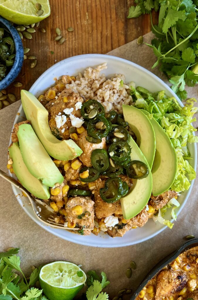 Honey-glazed jalapeños, the creamiest salty and sweet Mexican corn dip, and crispy spiced chicken all thrown together over your fav grain: these Mexican Street Corn Chicken and Jalapeño Bowls are a game-changing dinner.